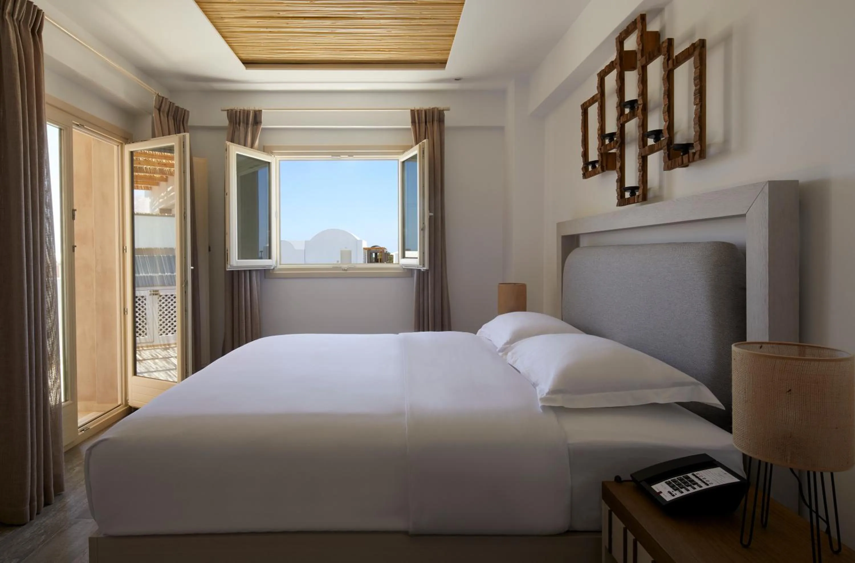 Bed in Sea Breeze Santorini Beach Resort, Curio By Hilton