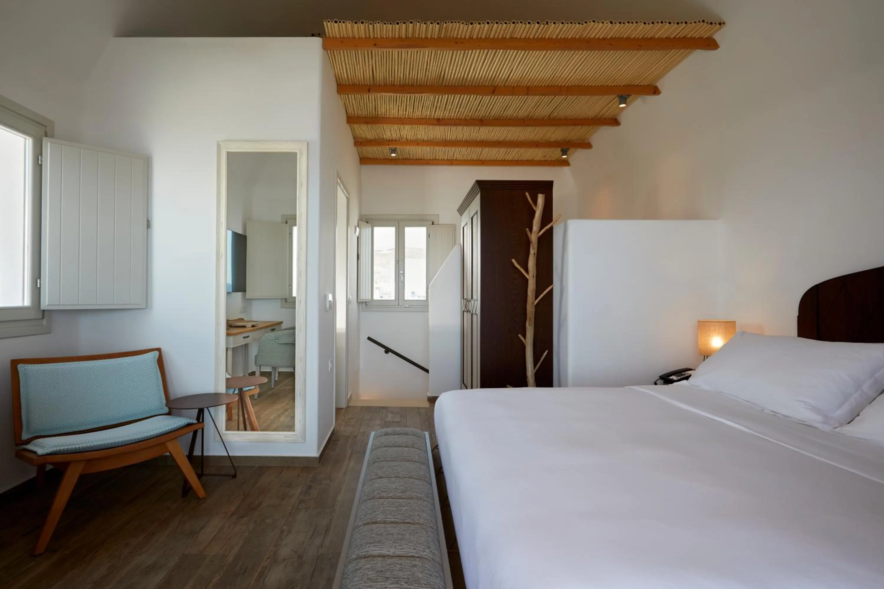 Bed in Sea Breeze Santorini Beach Resort, Curio By Hilton