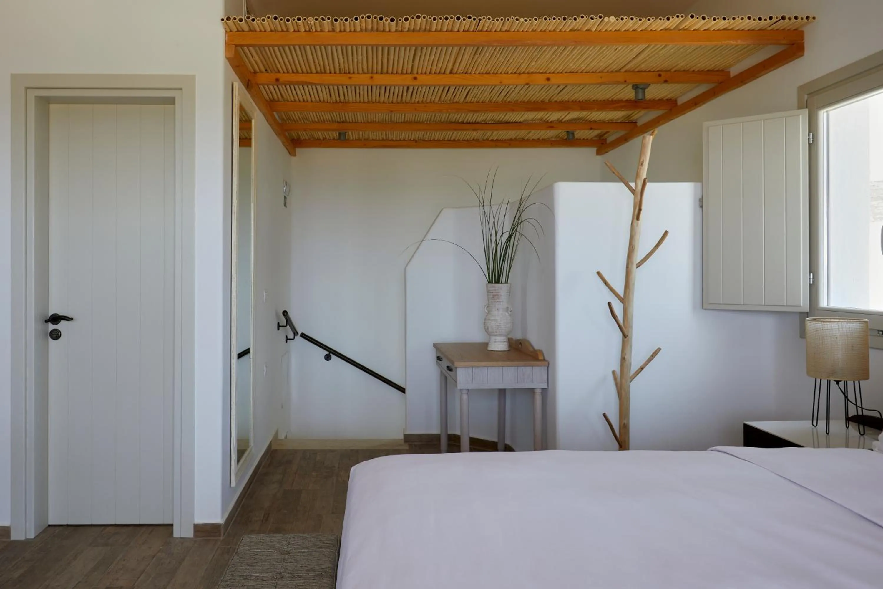 Bed in Sea Breeze Santorini Beach Resort, Curio By Hilton