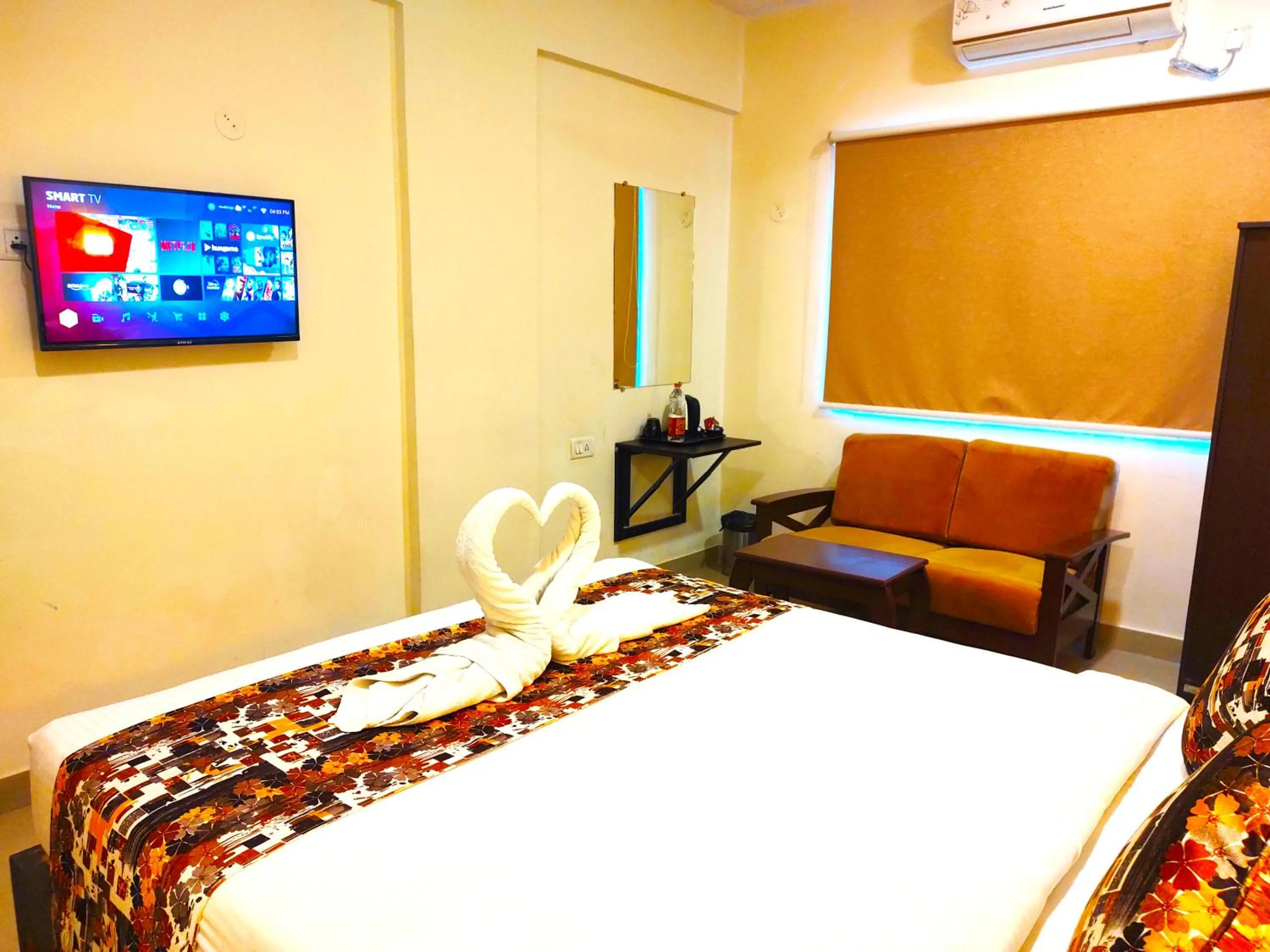 Communal lounge/ TV room in Athasri Hotel HSR Layout
