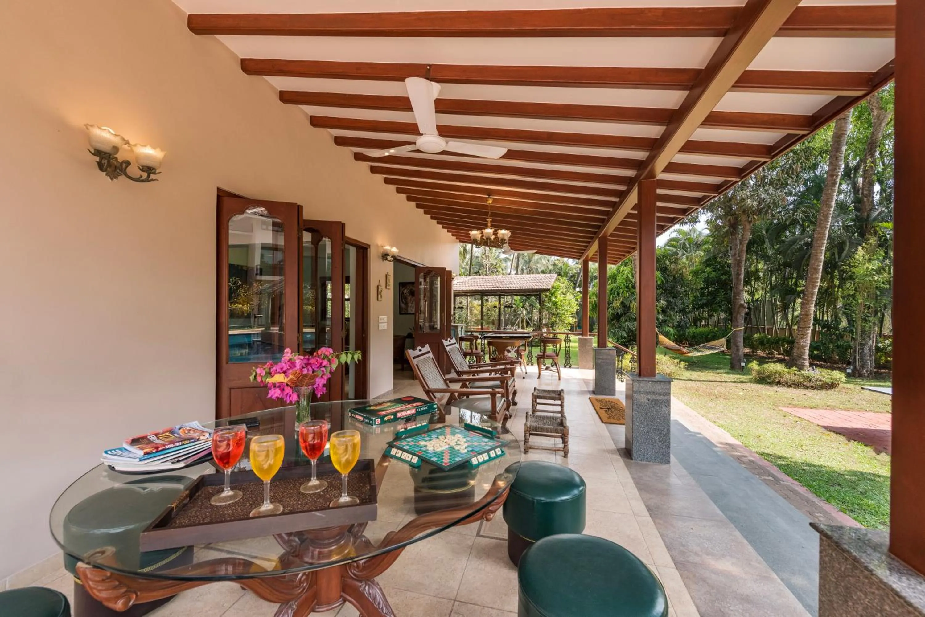 Patio in SaffronStays Casa Del Palms - 8BR luxury pool villa with gazebo, pickleball, bar & lawns near Nagaon Beach