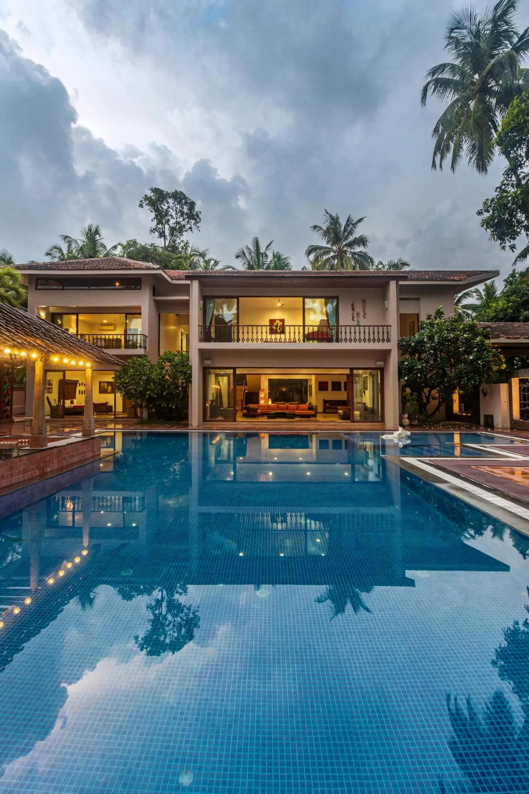 Property building in SaffronStays Casa Del Palms - 8BR luxury pool villa with gazebo, pickleball, bar & lawns near Nagaon Beach