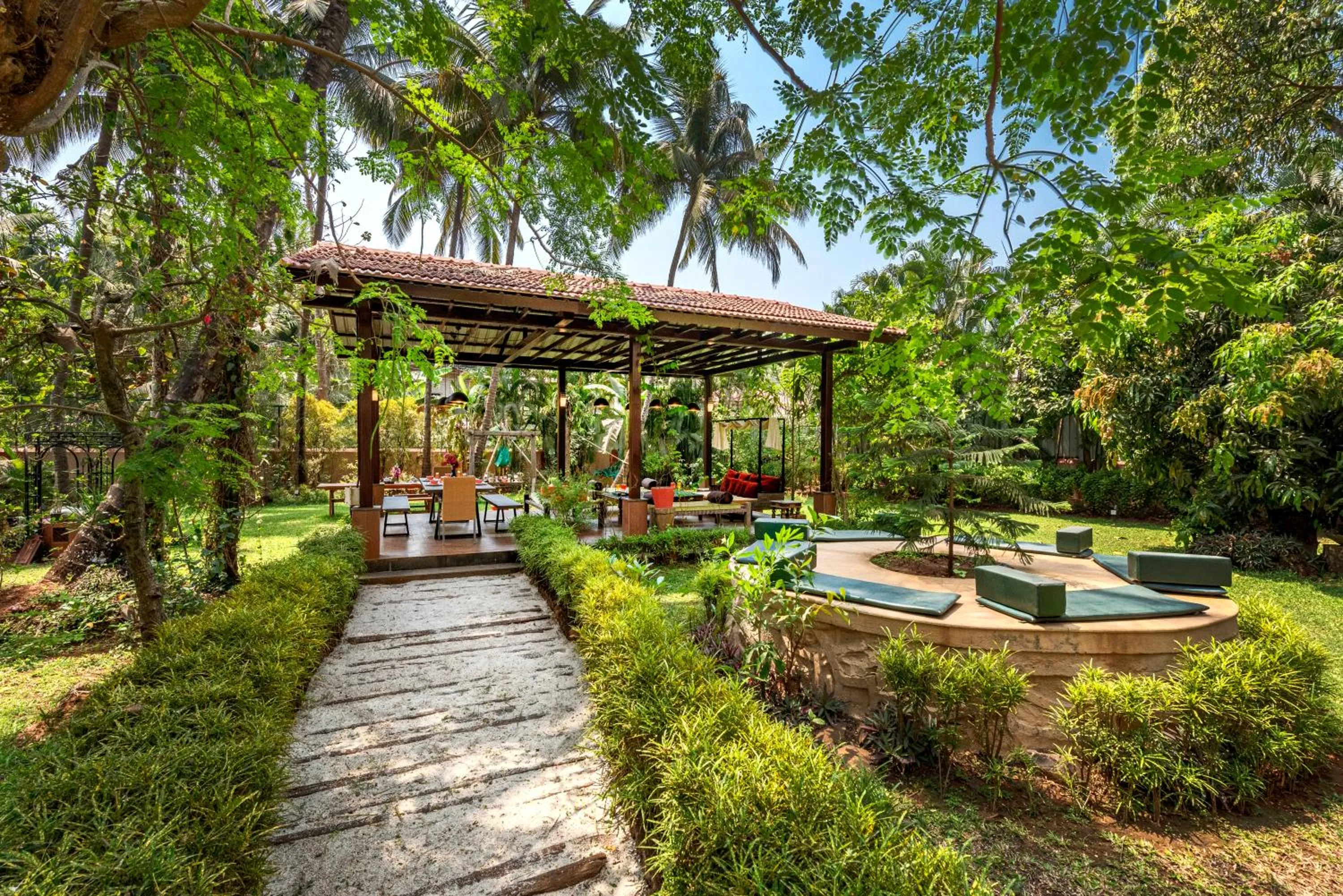 Patio in SaffronStays Casa Del Palms - 8BR luxury pool villa with gazebo, pickleball, bar & lawns near Nagaon Beach