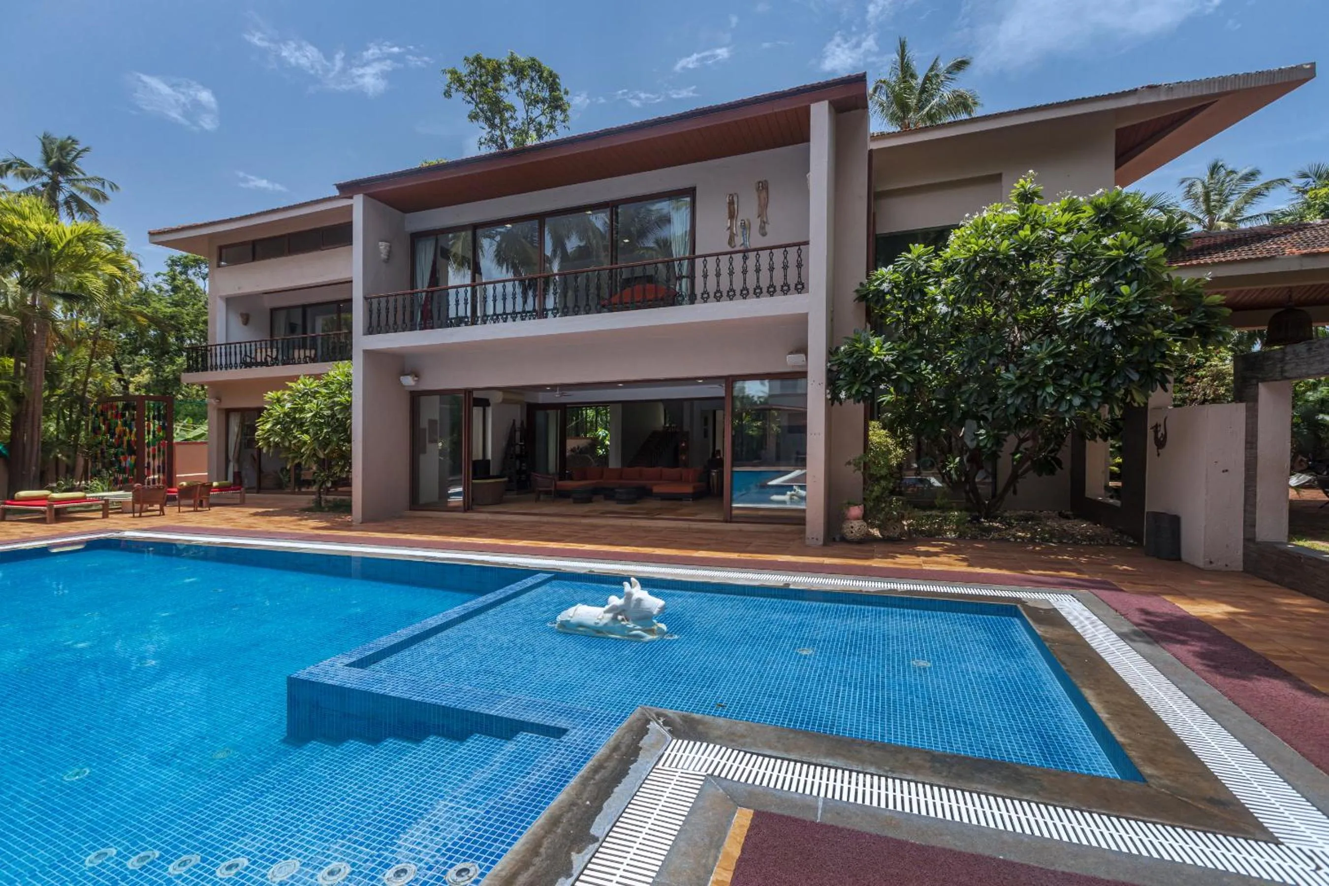 Property building in SaffronStays Casa Del Palms - 8BR luxury pool villa with gazebo, pickleball, bar & lawns near Nagaon Beach