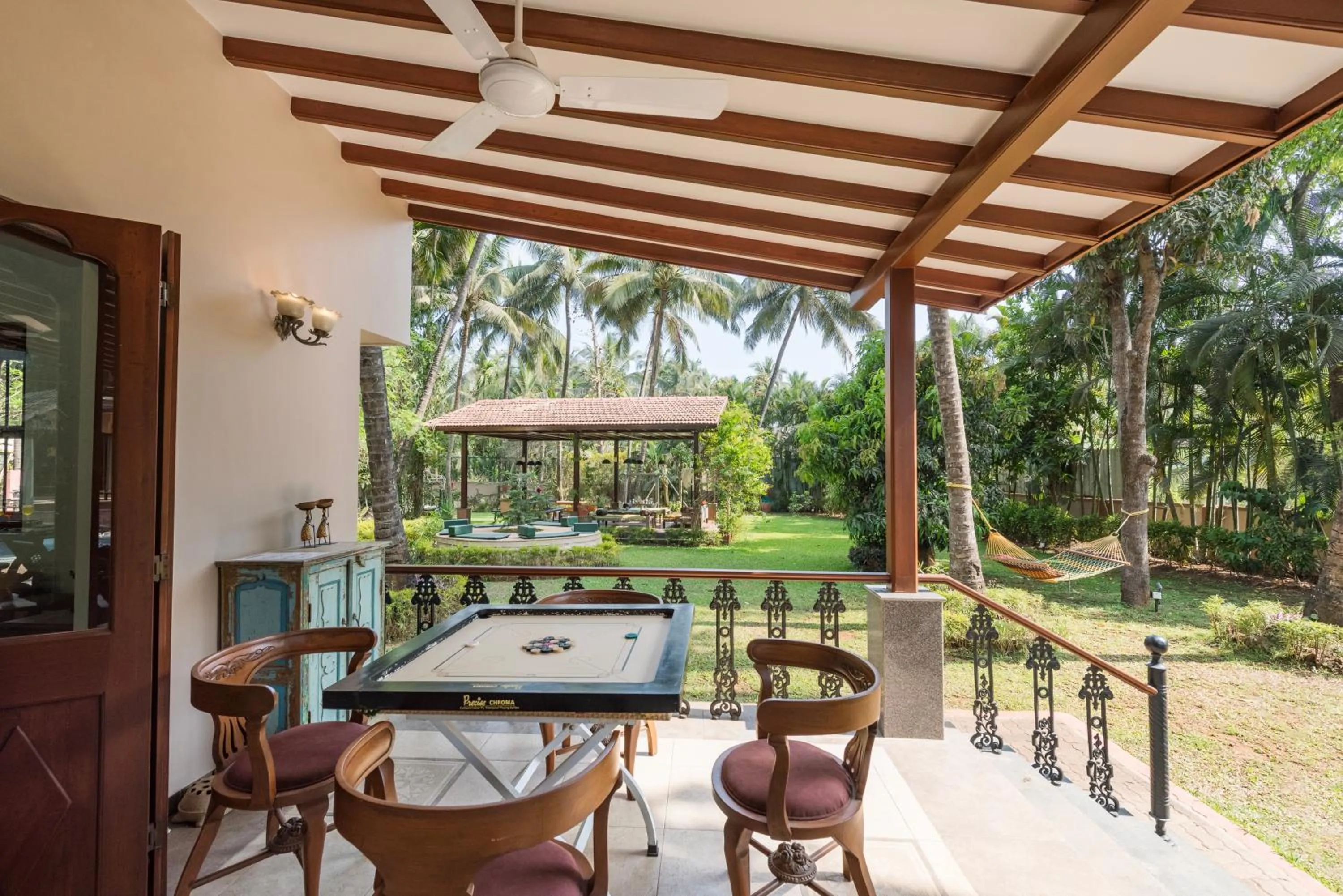 Patio in SaffronStays Casa Del Palms - 8BR luxury pool villa with gazebo, pickleball, bar & lawns near Nagaon Beach