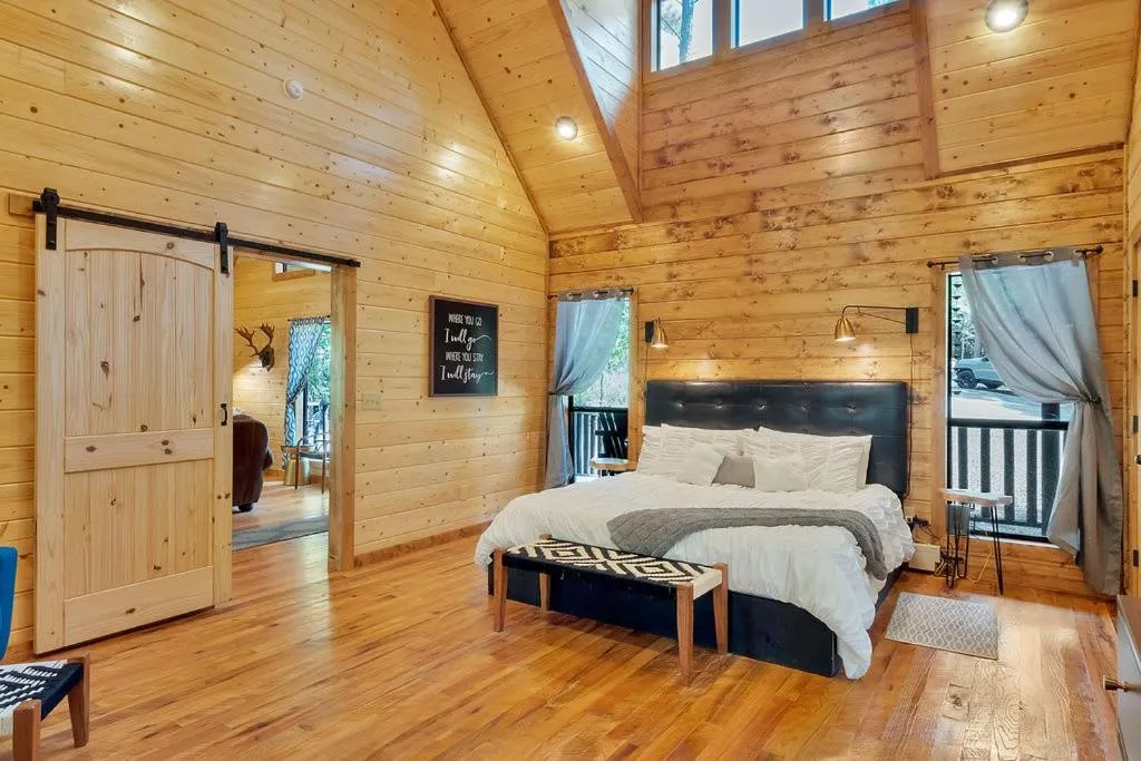 Bed in Gorgeous Idyllic Cabin w Hot Tub and Fire Pit Quittin Time is Secluded Romantic Oasis w Luxury Bathroom Double Shower and Bathtub Foosball Table