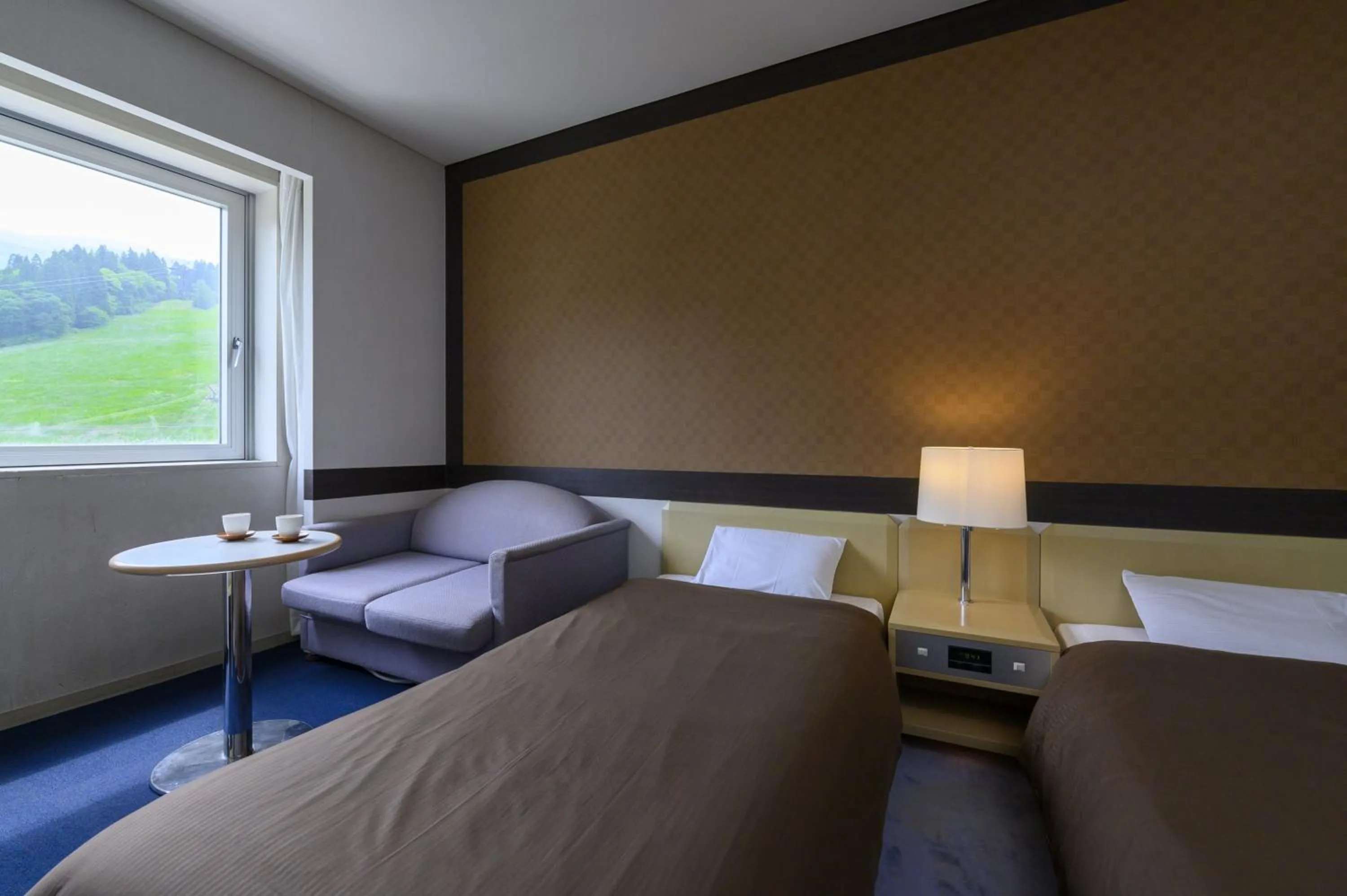 Bed in Takamiya Hotel Rurikura Resort