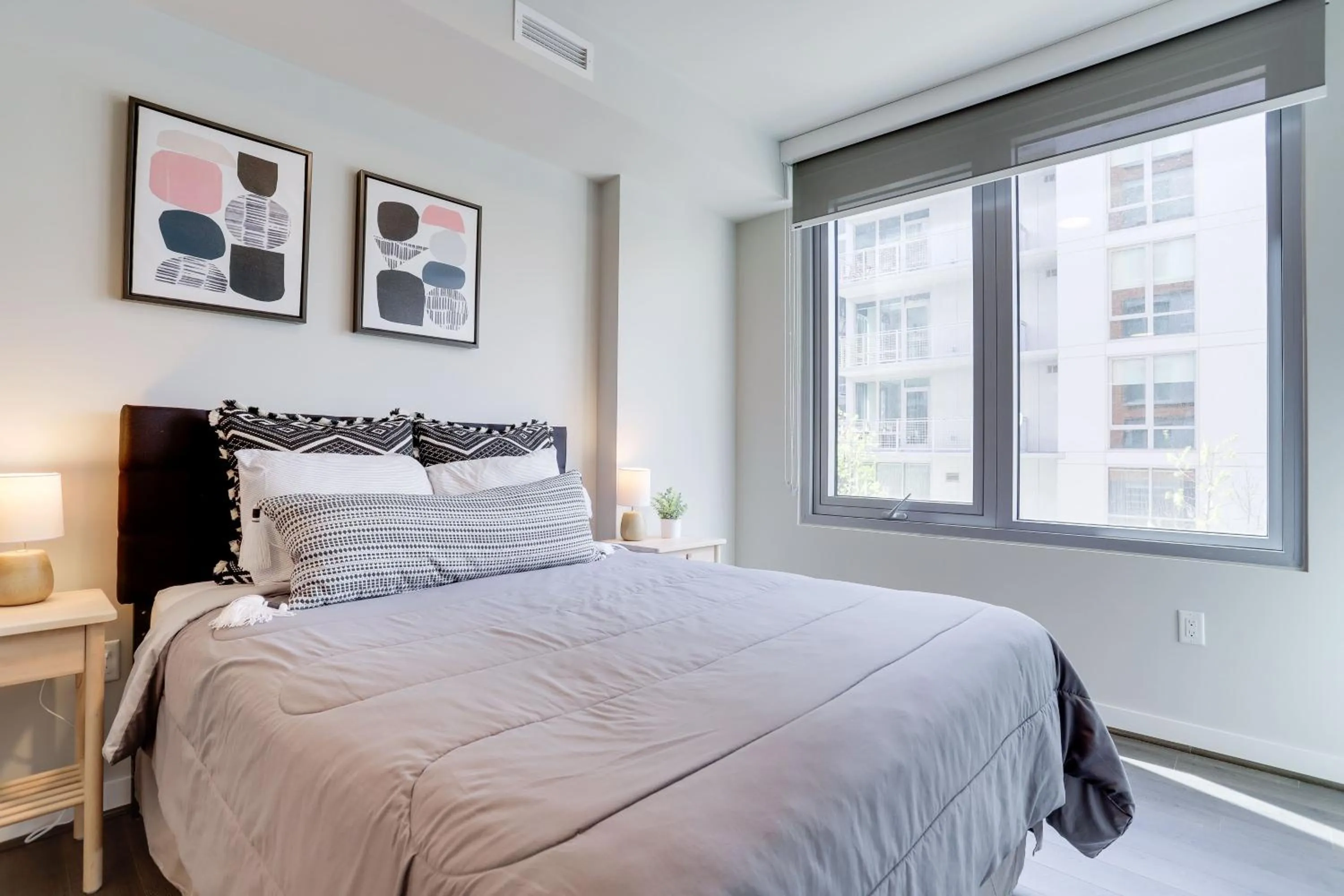 Bed in Stylish Condo at Clarendon with Rooftop Views
