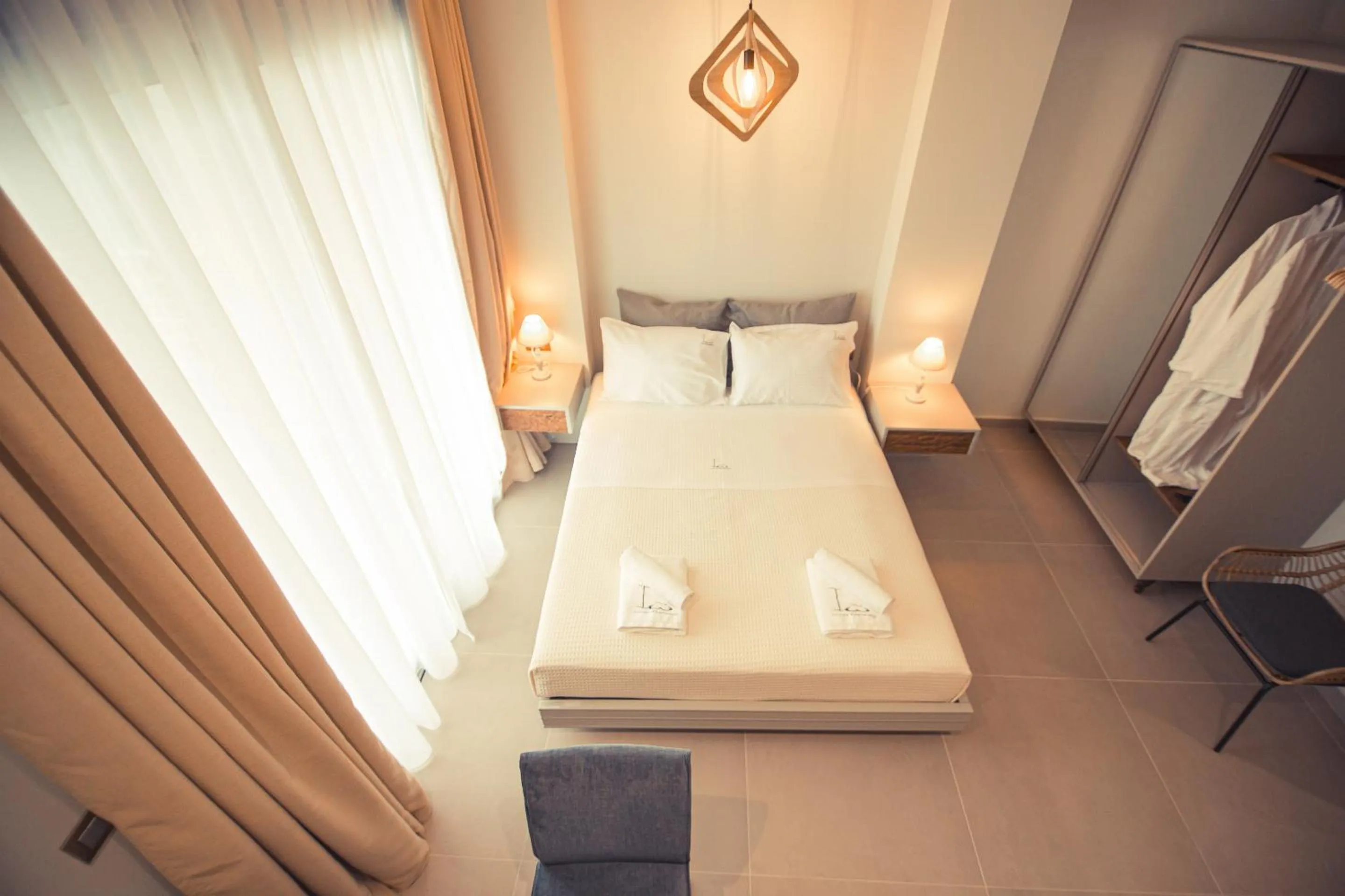 Bed in IO Luxury Pool & Hot Tub Suites