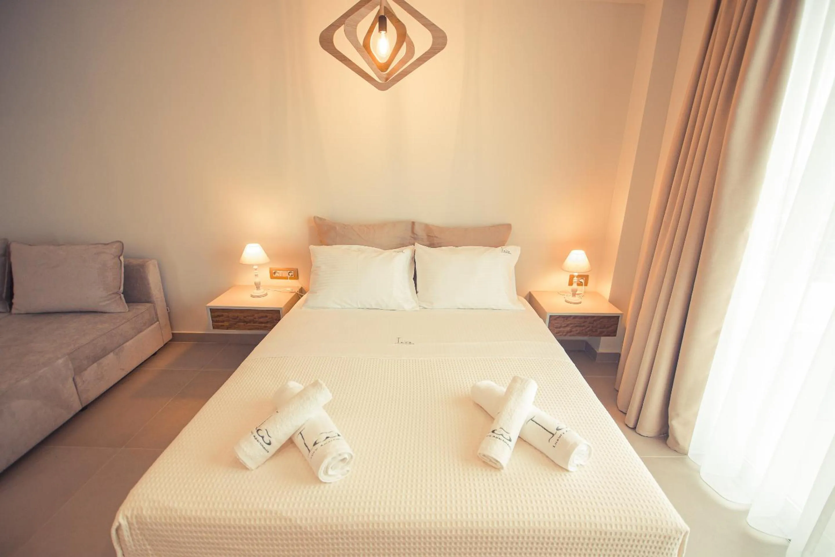 Bed in IO Luxury Pool & Hot Tub Suites