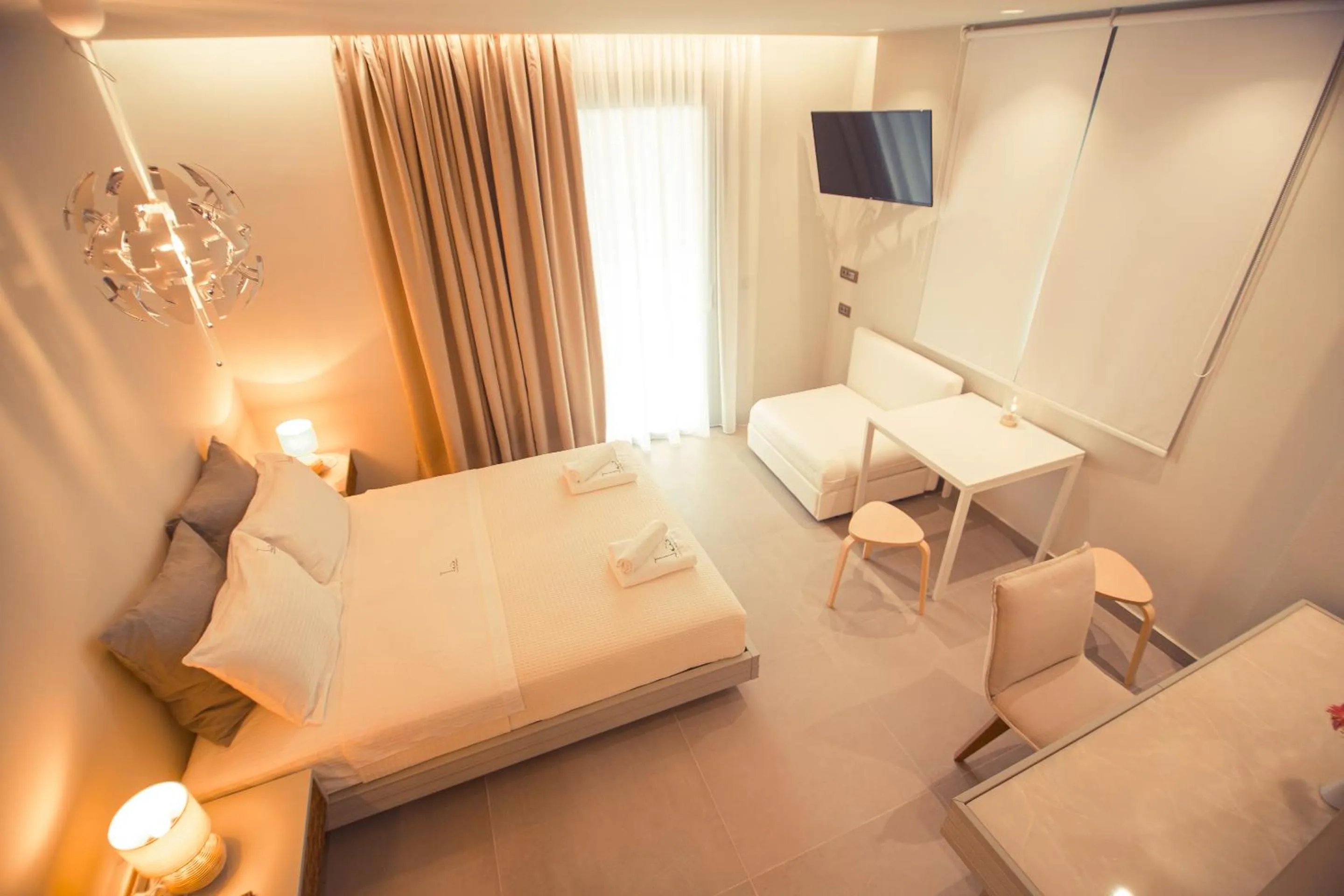 Bed in IO Luxury Pool & Hot Tub Suites