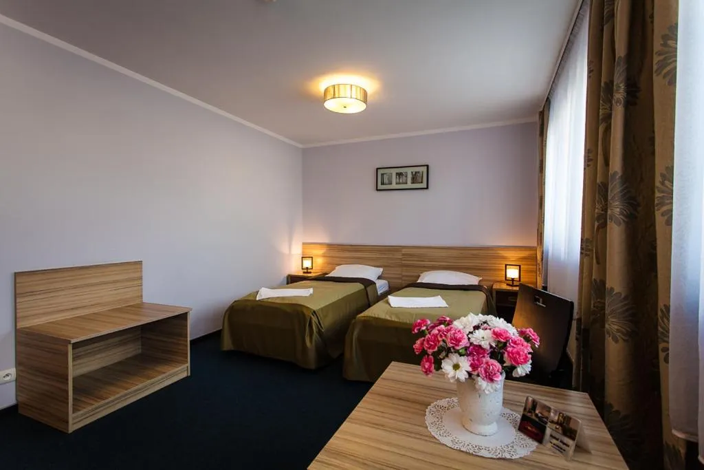 Communal lounge/ TV room, Bed in Hotel Alpex