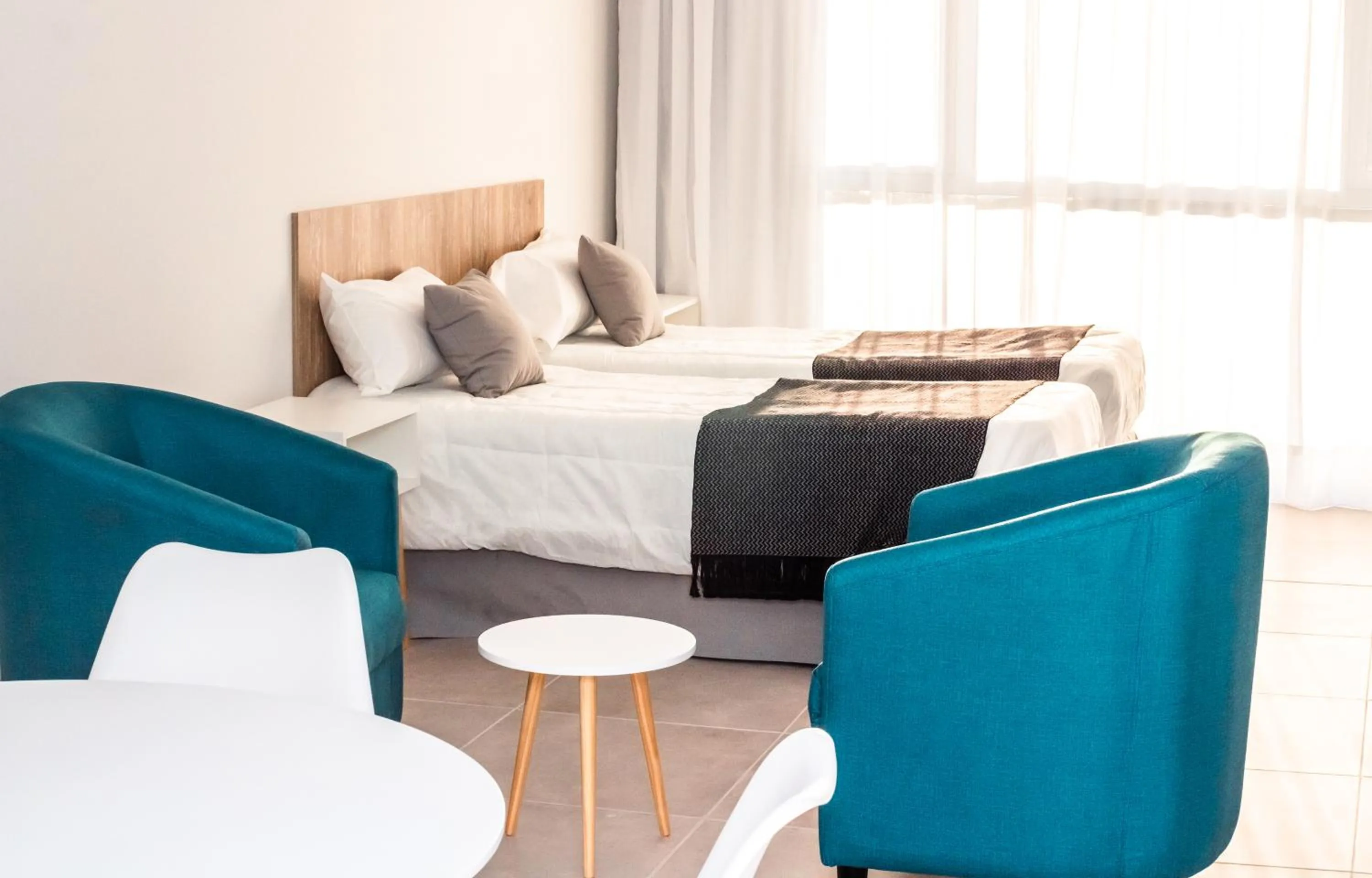 Living room, Bed in Ramada Residences by Wyndham Puerto Madryn CQ Mitre