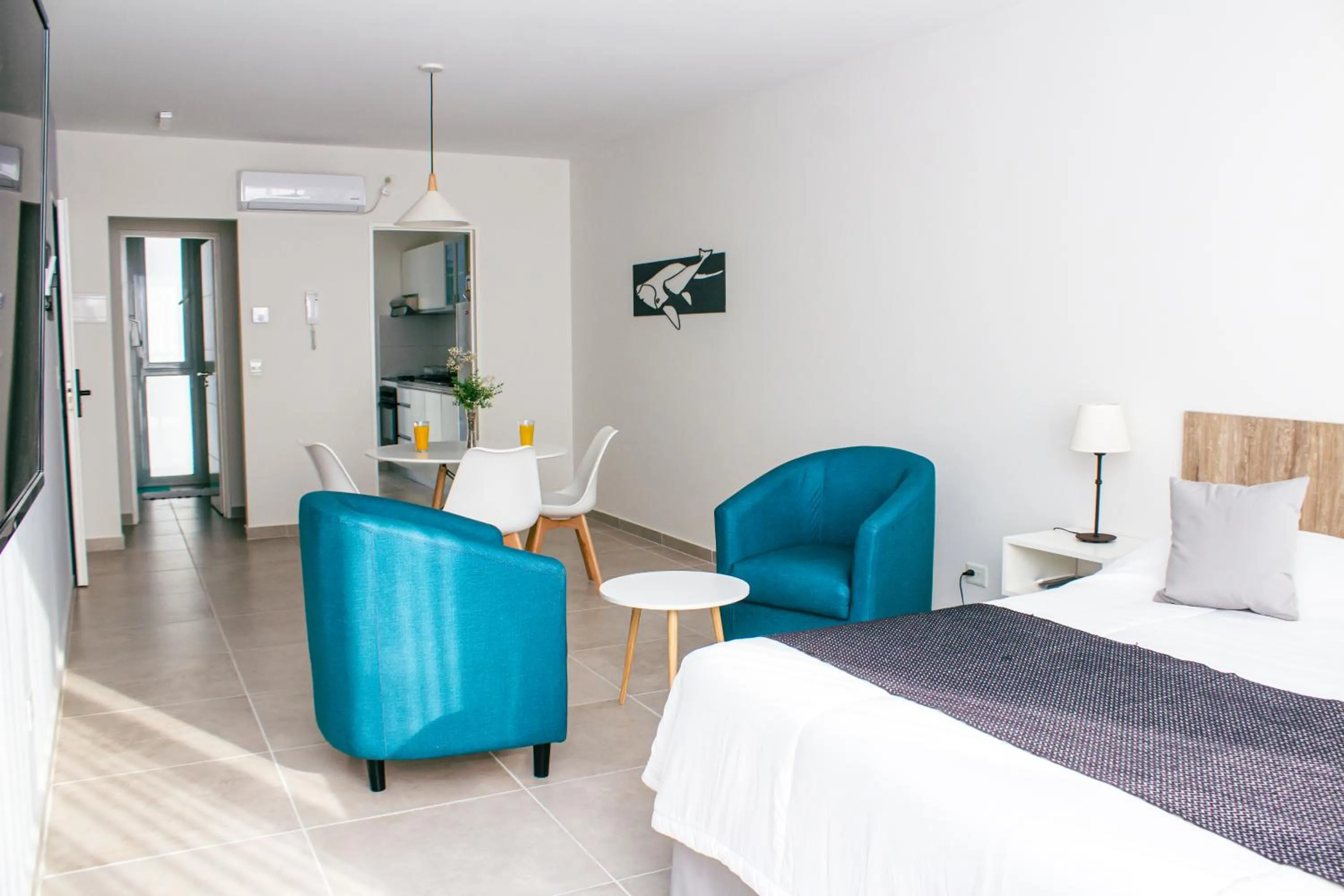 Living room, Bed in Ramada Residences by Wyndham Puerto Madryn CQ Mitre