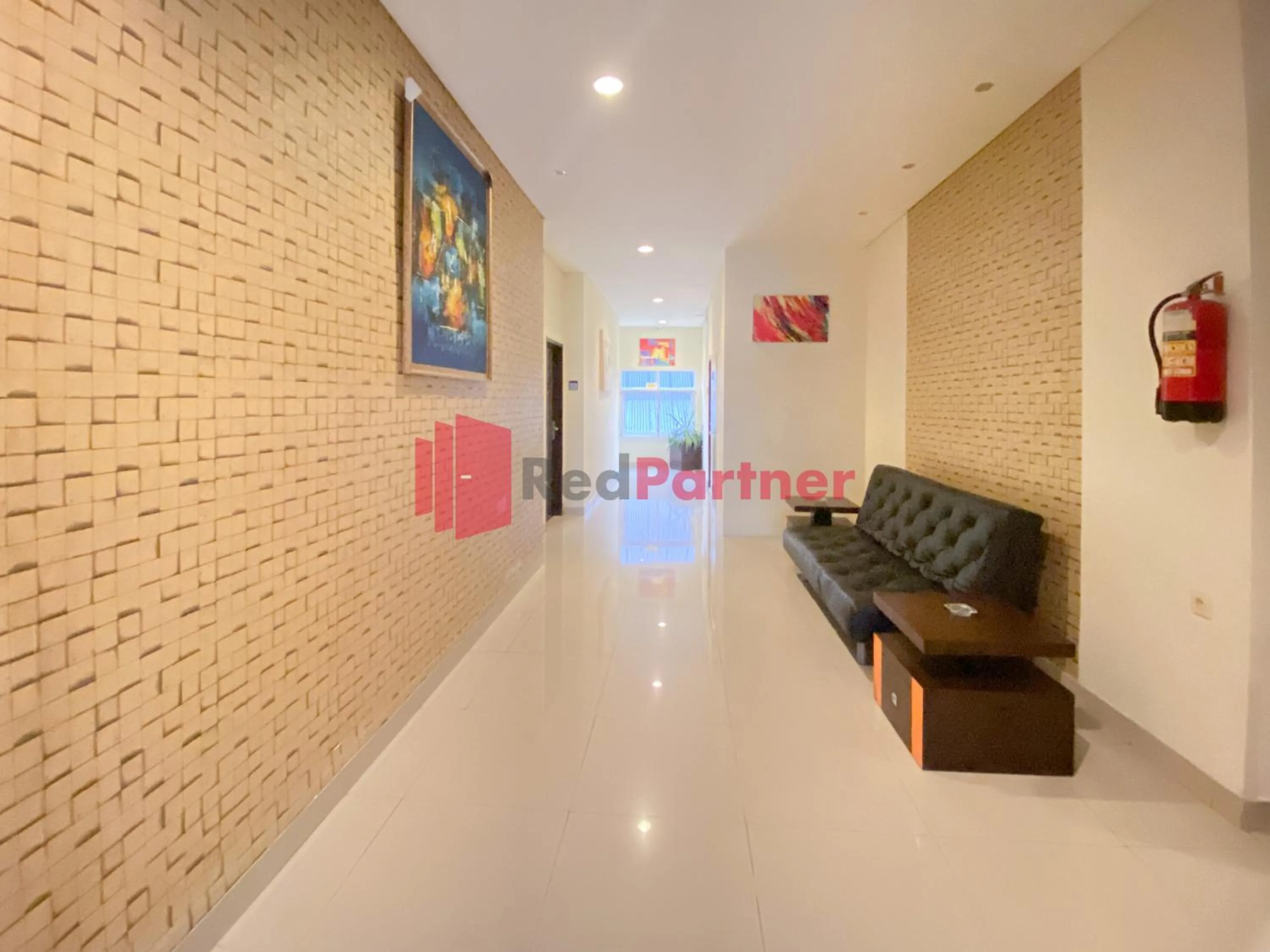 Seating area in Hotel Alpha Makassar RedPartner