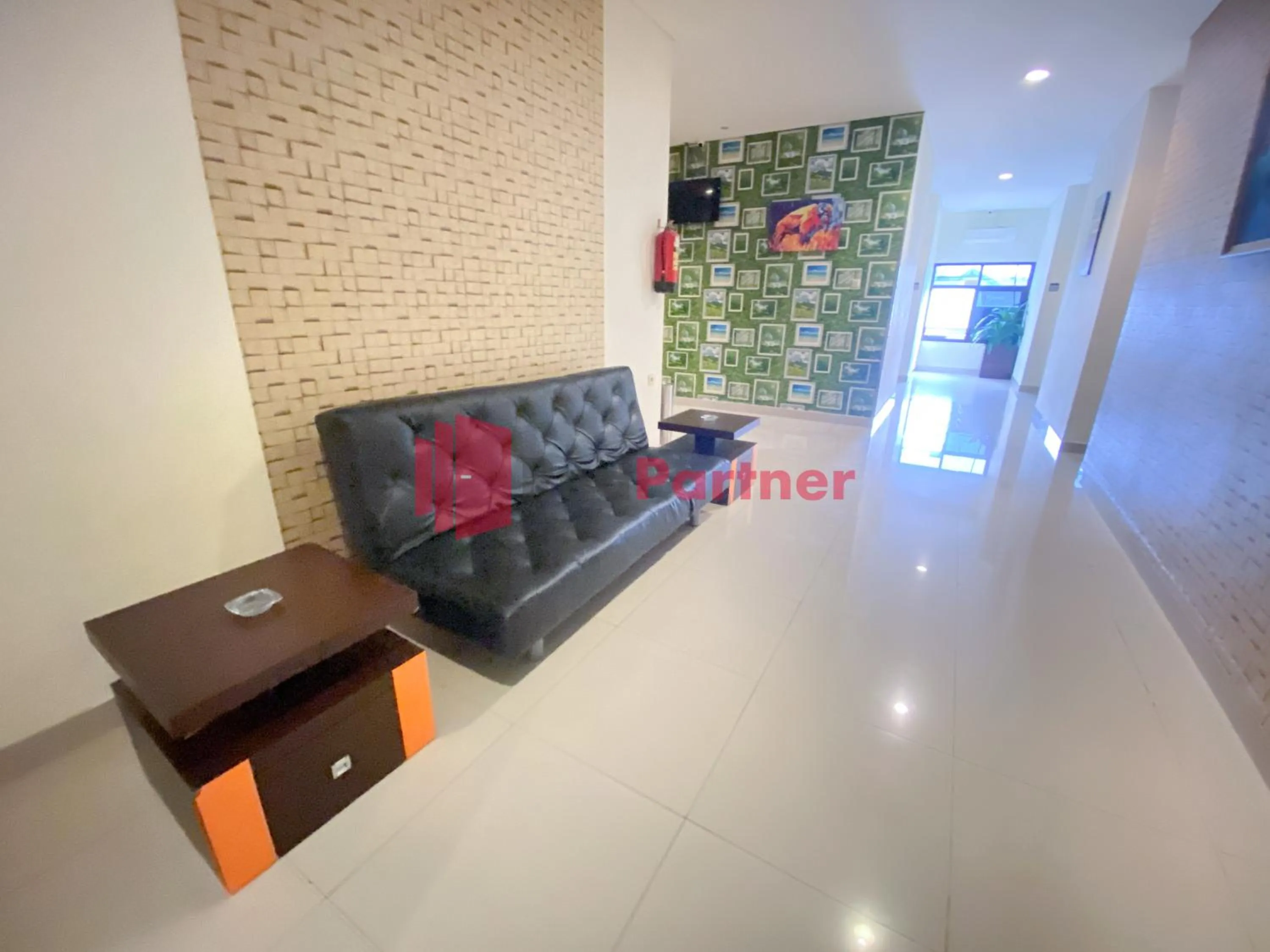 Seating area in Hotel Alpha Makassar RedPartner