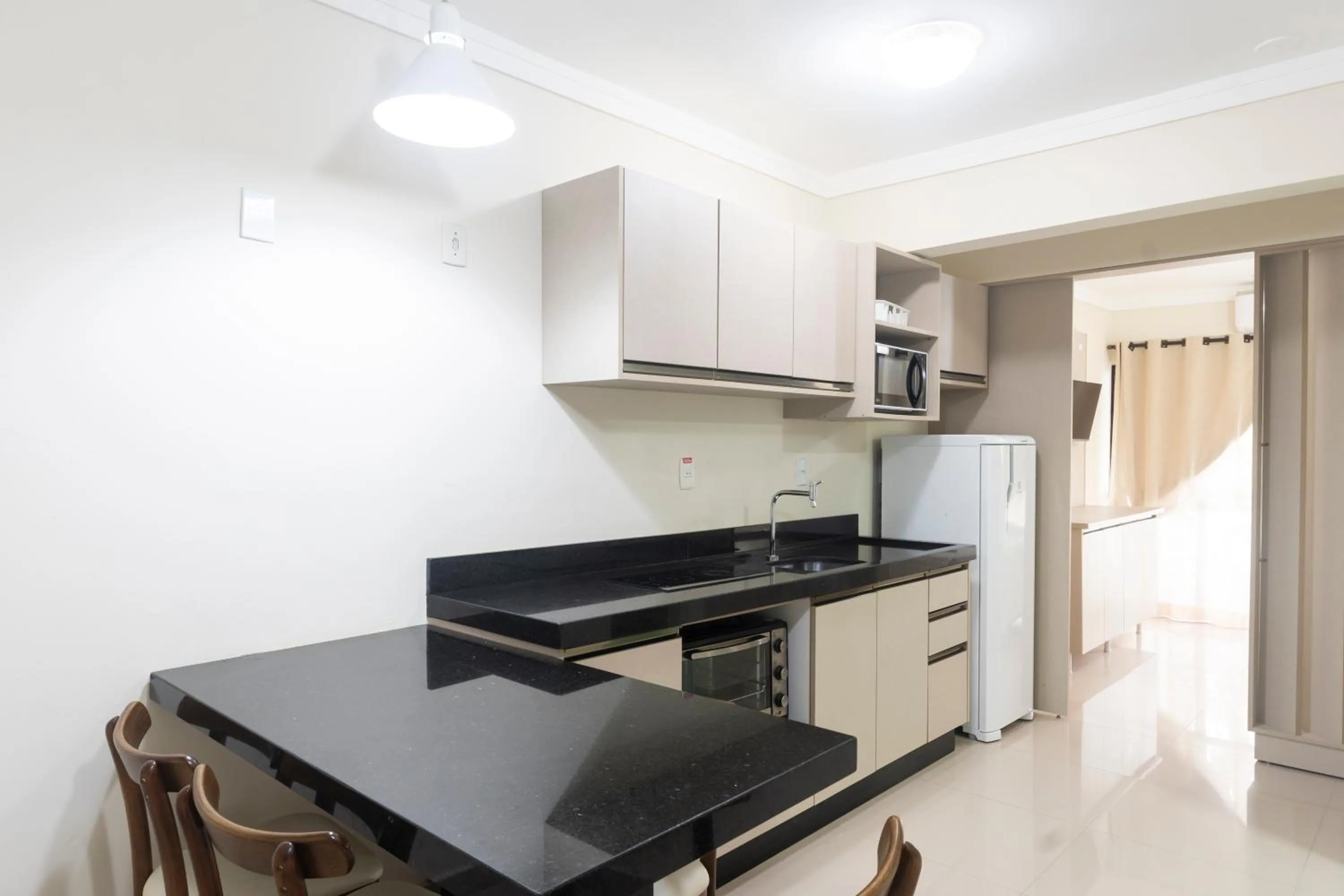 kitchen in Bombinhas Tourist Apart