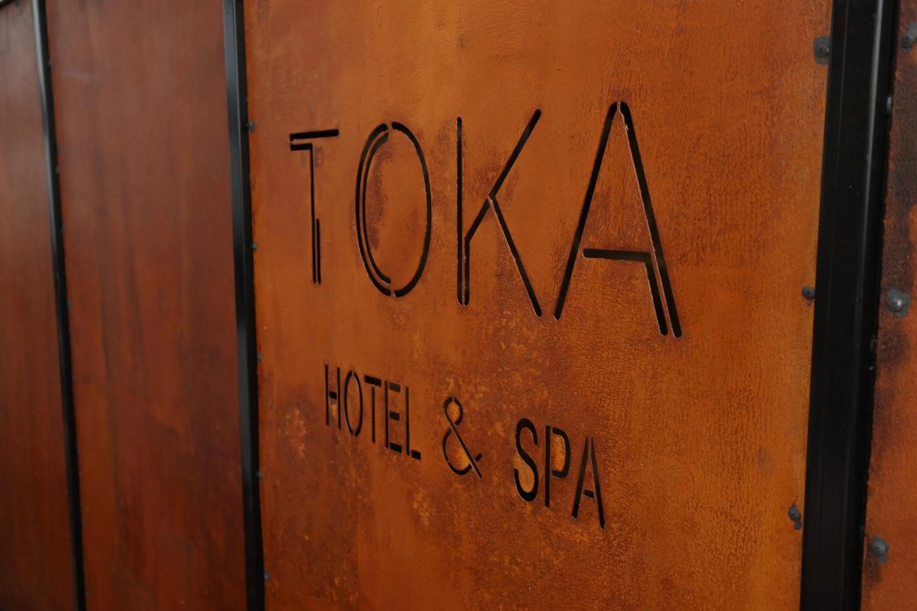 Property logo or sign in Toka Hotel Restaurant