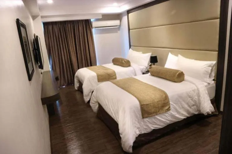 Bed in My Happy Place West Avenue Suites