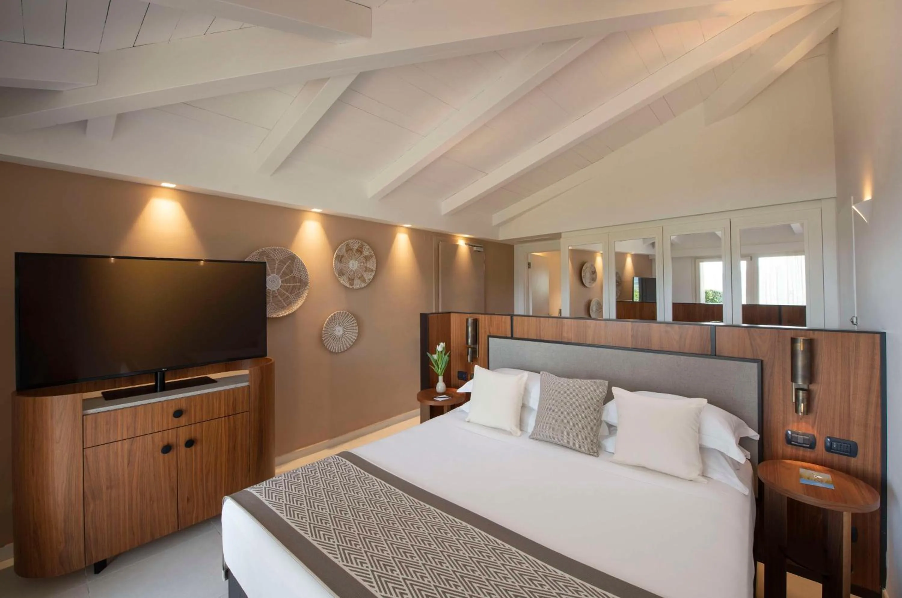 Bed in Baia Di Chia Resort Sardinia, Curio Collection By Hilton