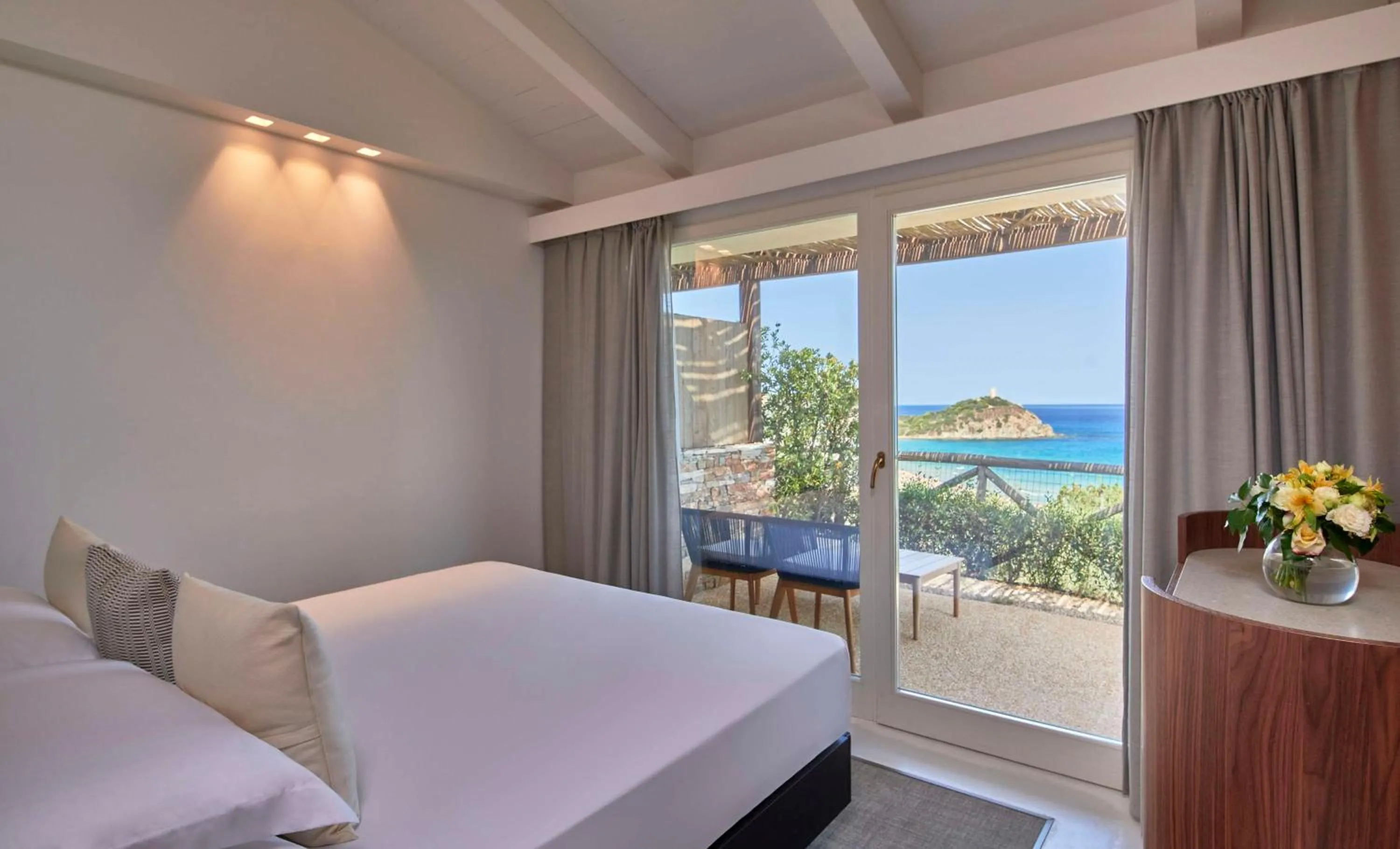 Bed in Baia Di Chia Resort Sardinia, Curio Collection By Hilton