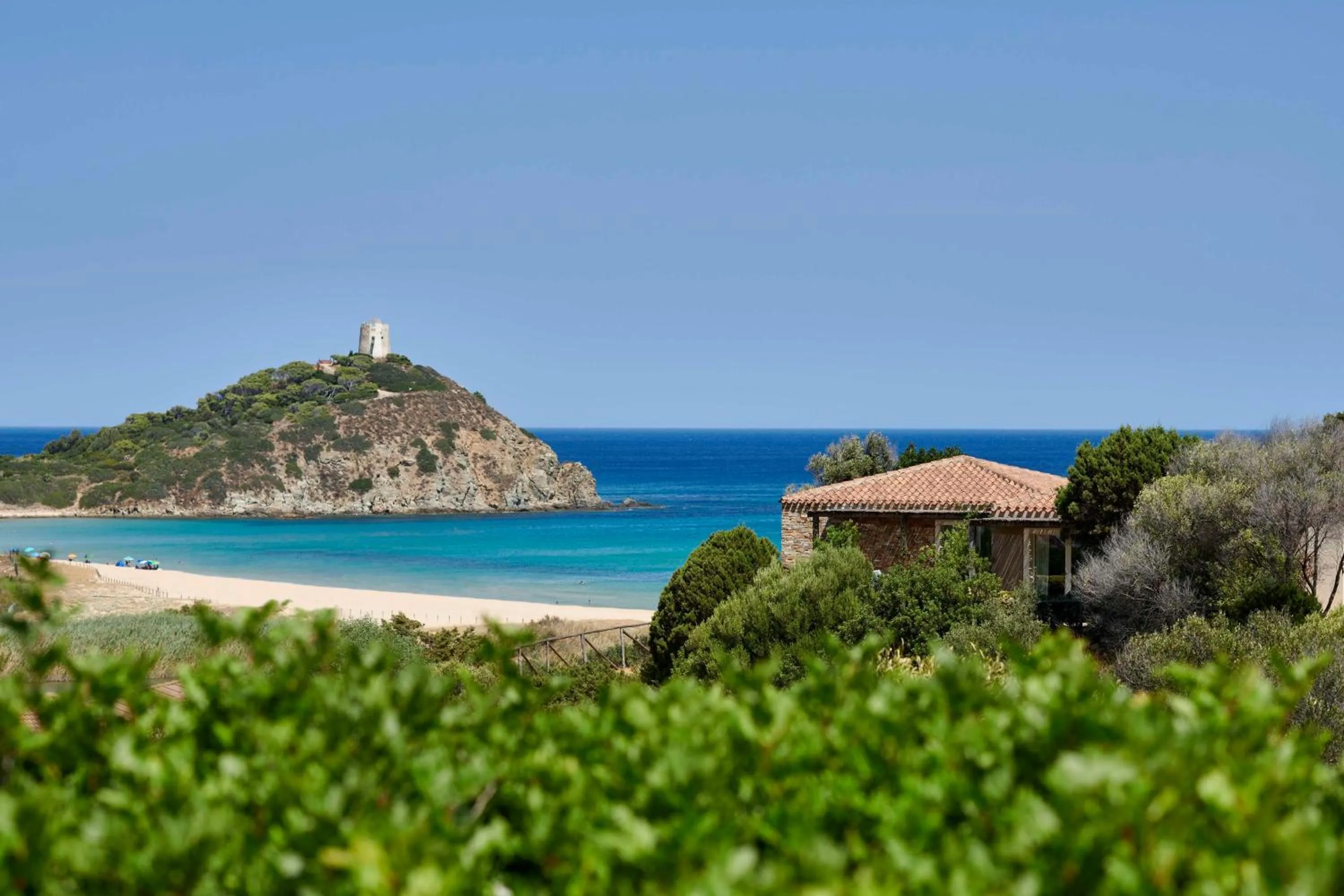 Property building in Baia Di Chia Resort Sardinia, Curio Collection By Hilton
