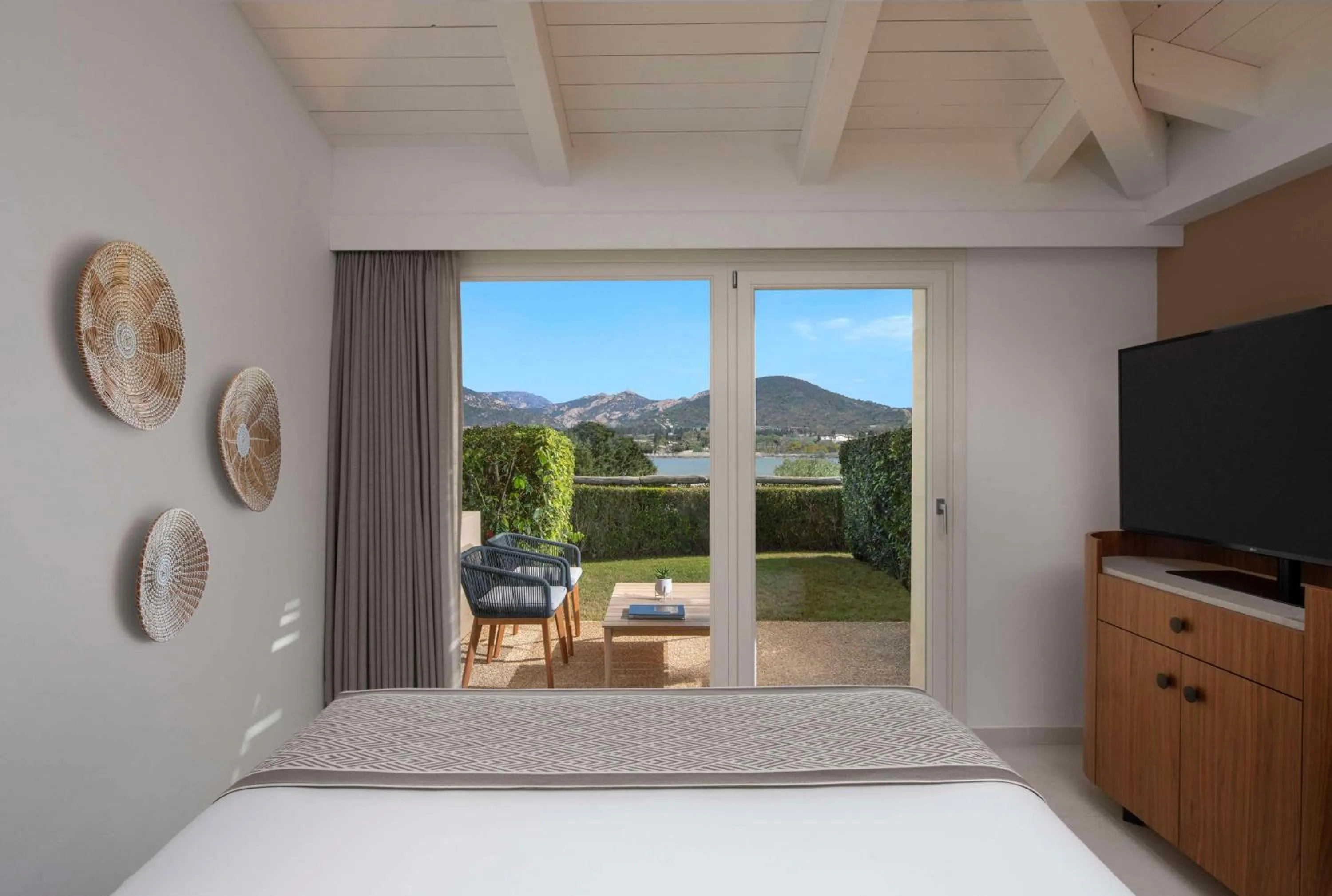 Bed in Baia Di Chia Resort Sardinia, Curio Collection By Hilton