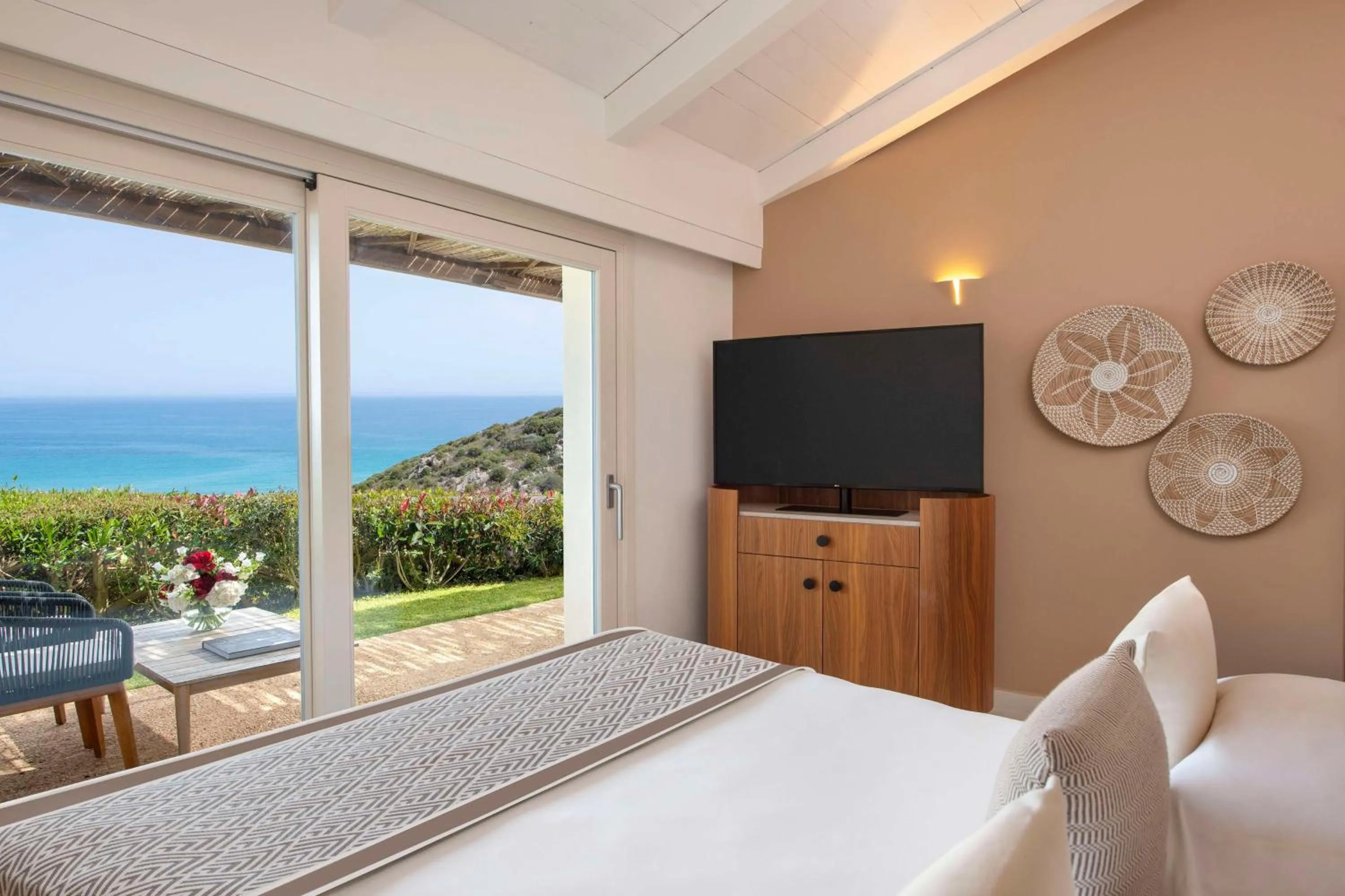 Bed in Baia Di Chia Resort Sardinia, Curio Collection By Hilton