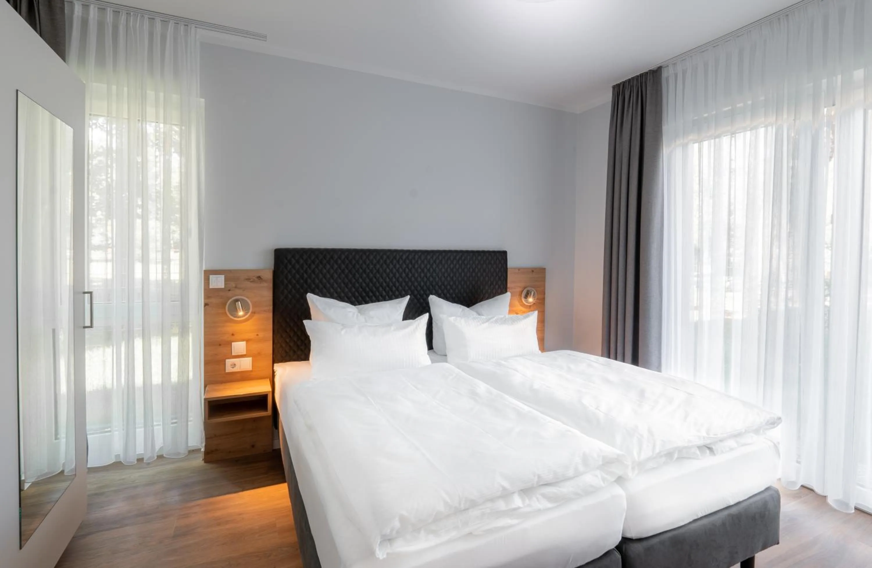 Bedroom, Bed in Sporthotel Neuruppin - Apartmenthaus mit Ferienwohnungen