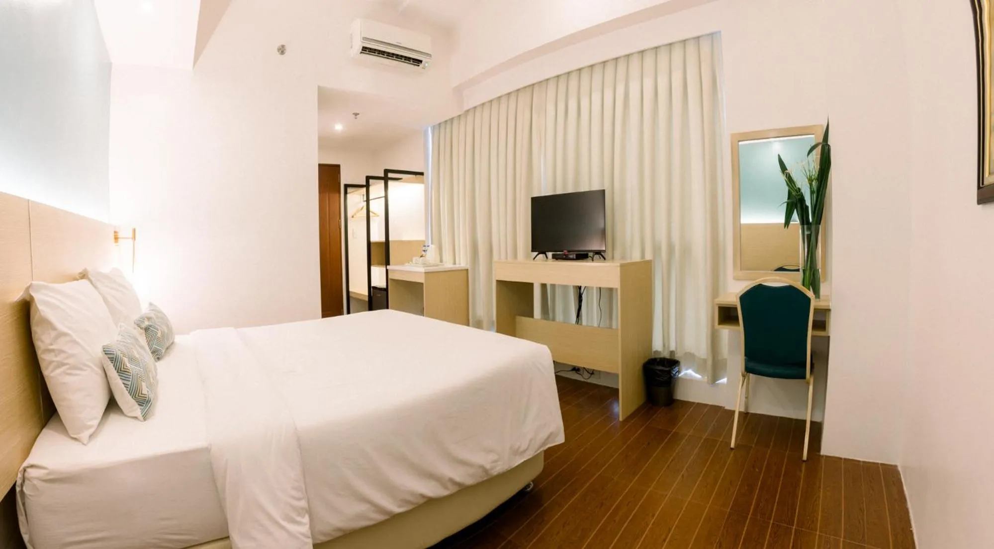 Bed in Allure Hotel & Suites