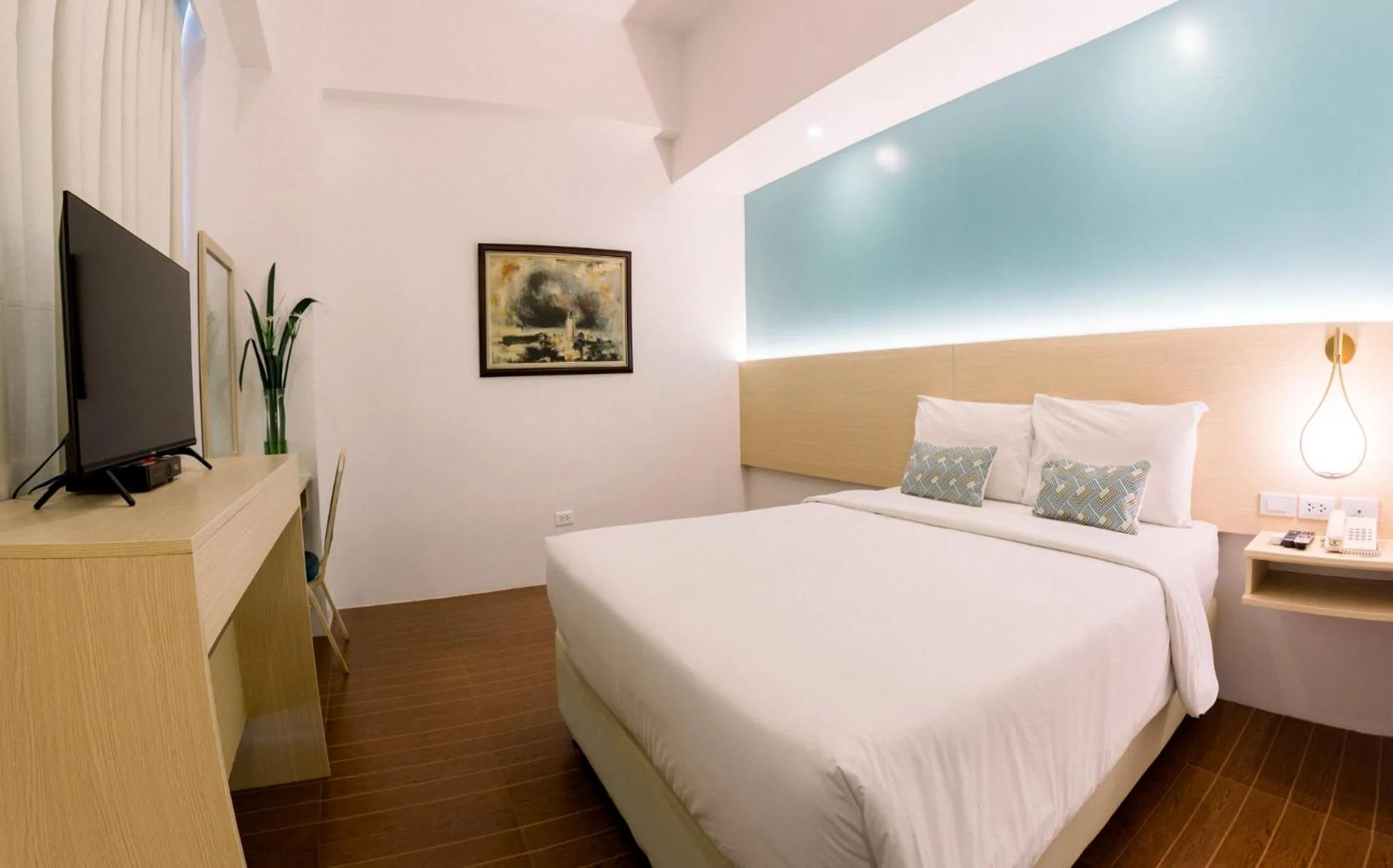 Bed in Allure Hotel & Suites