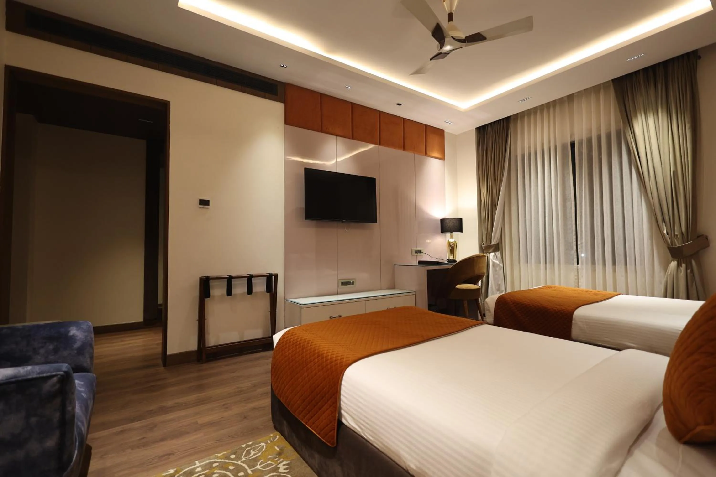 Communal lounge/ TV room, Bed in The Ramayana Hotel, Ayodhya