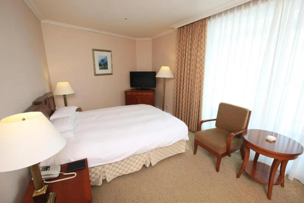 Bed in High1 Palace Hotel and CC