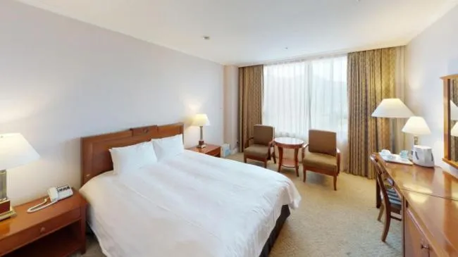 Bed in High1 Palace Hotel and CC