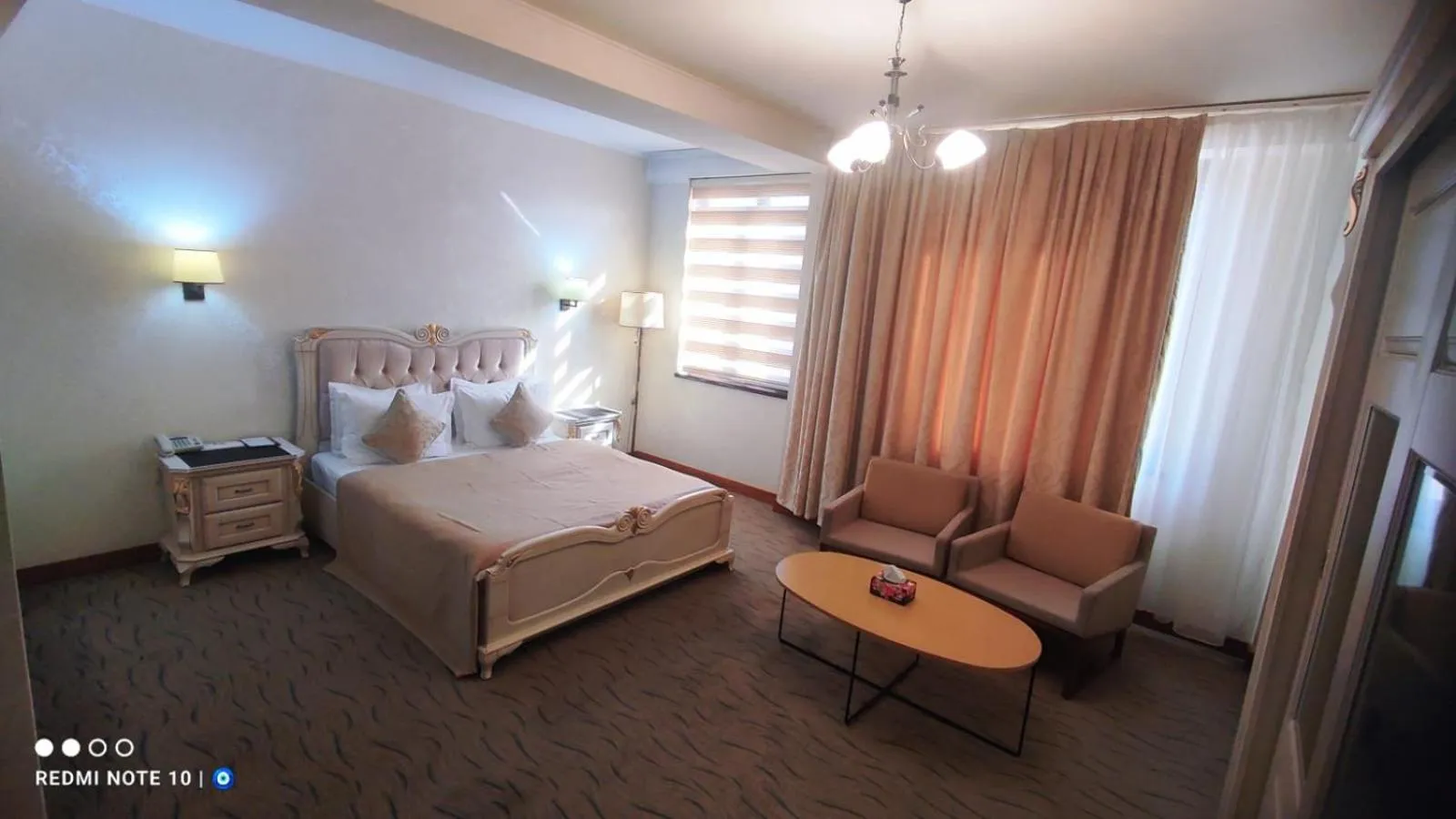 Seating area, Bed in Vego Hotel