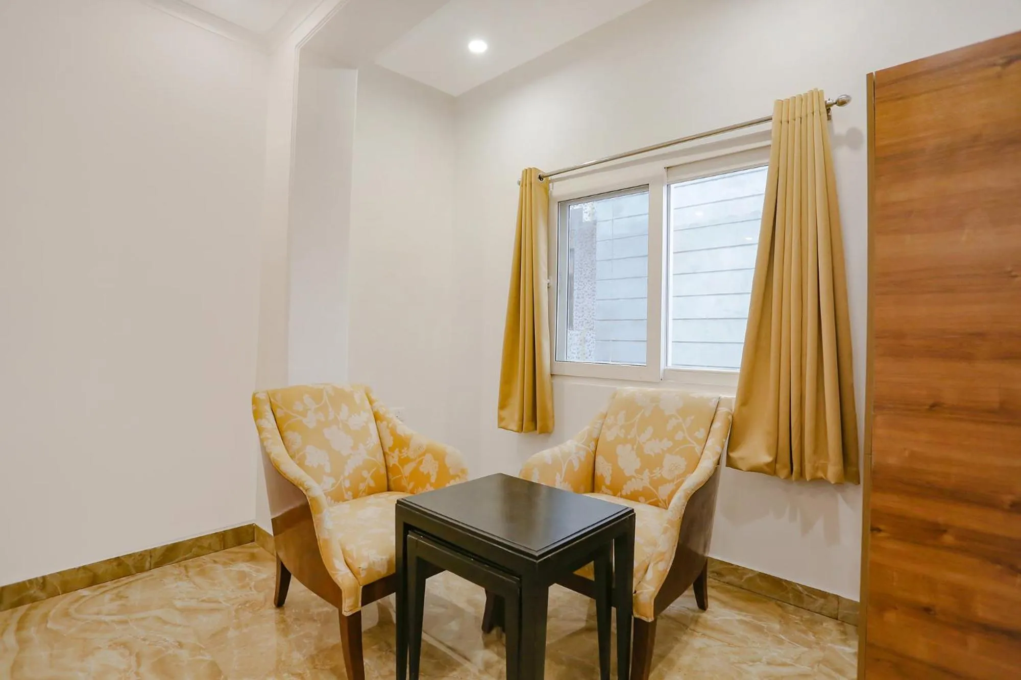 Seating area in FabExpress Taj Residency - Nr Yashobhoomi Convention Centre