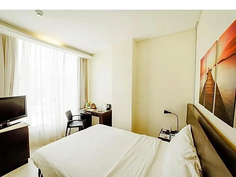 Bed in Ocean Suites Bohol Boutique Hotel