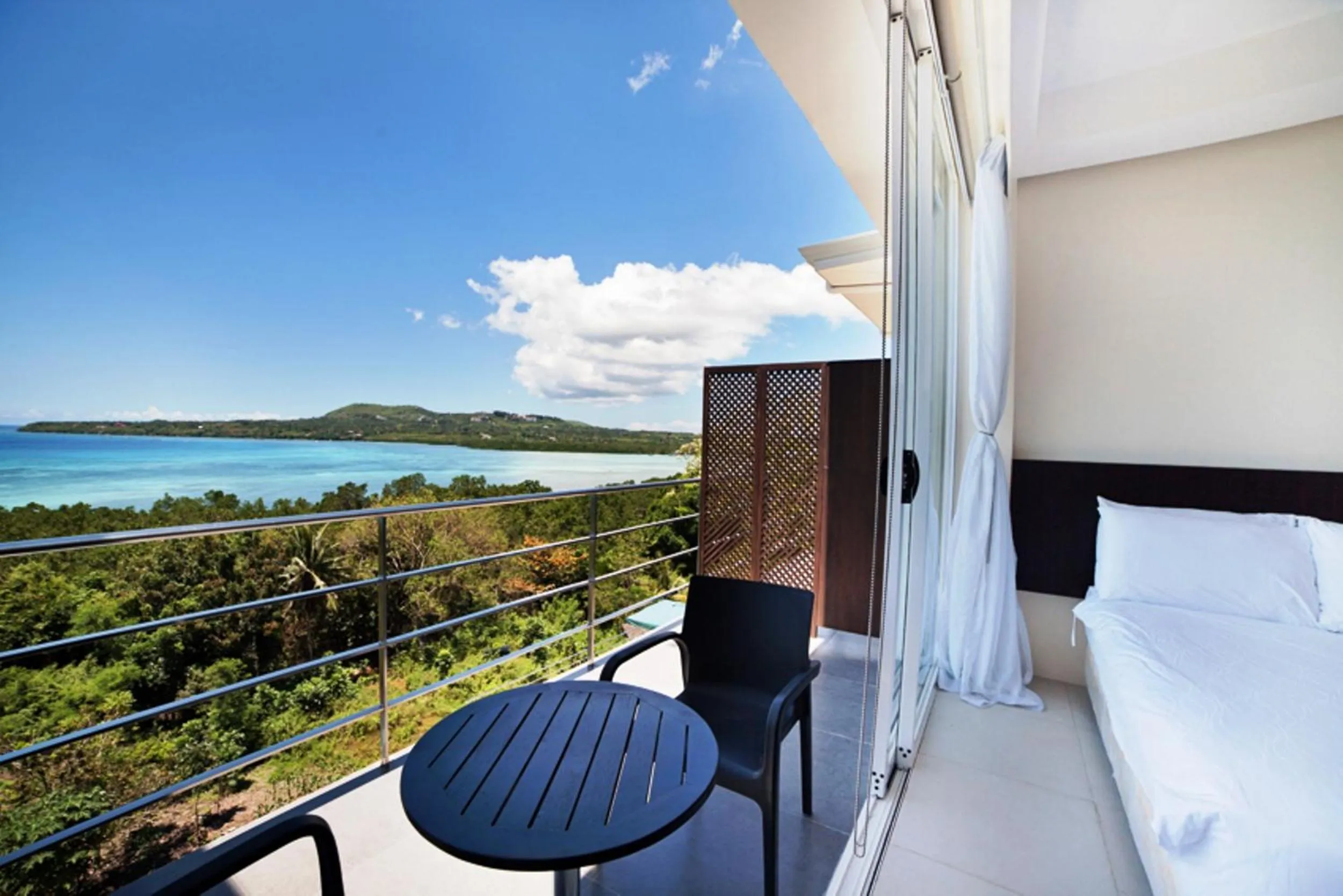 Balcony/Terrace, Bed in Ocean Suites Bohol Boutique Hotel