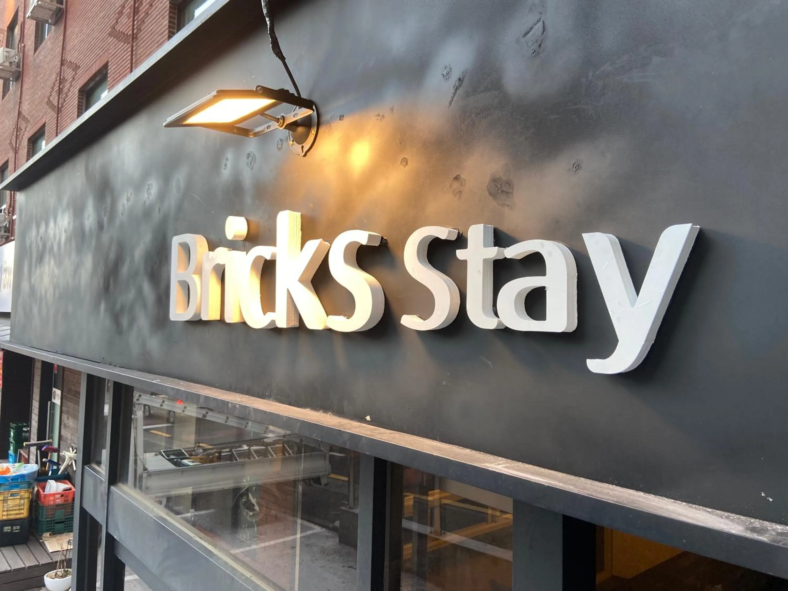 Property logo or sign in Bricks Stay Jeju City & Aiport