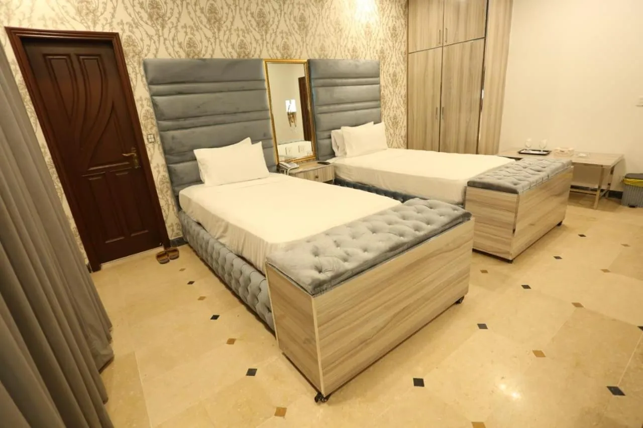 Bed in Grand Swiss Hotel&Apartment Lahore