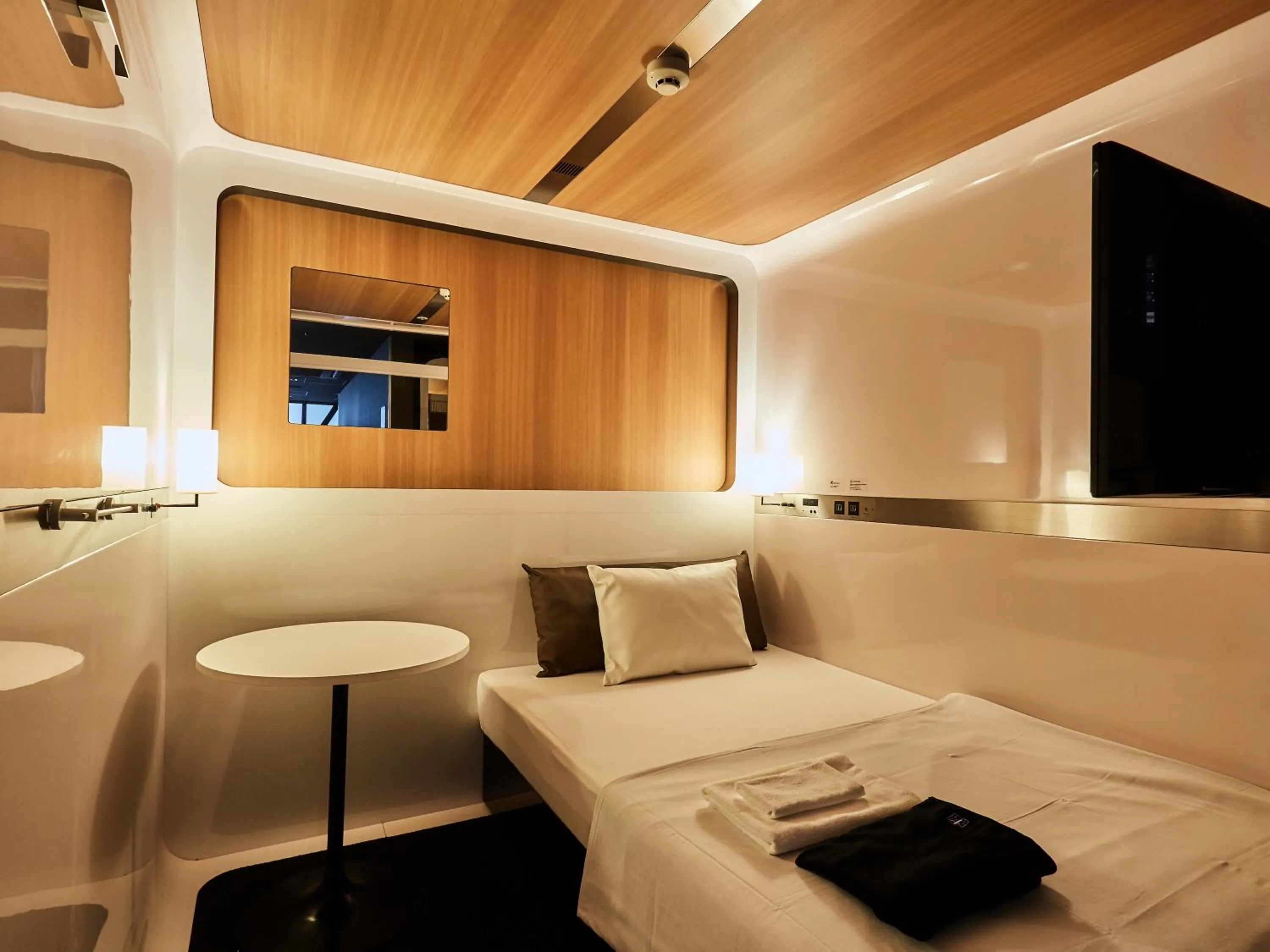 Photo of the whole room, Bed in First Cabin Nishi Umeda