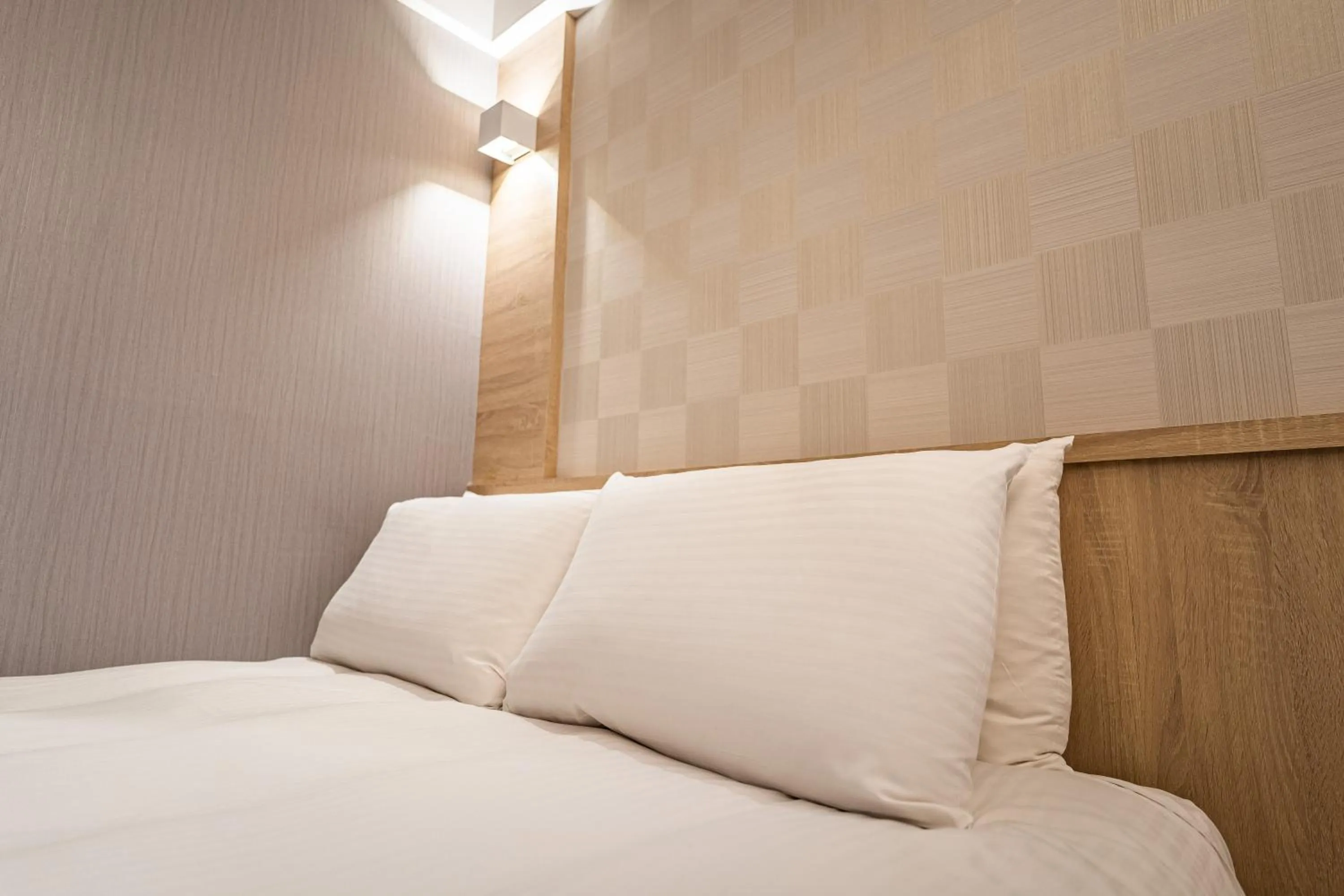 Bed in Global Traveler Hotel