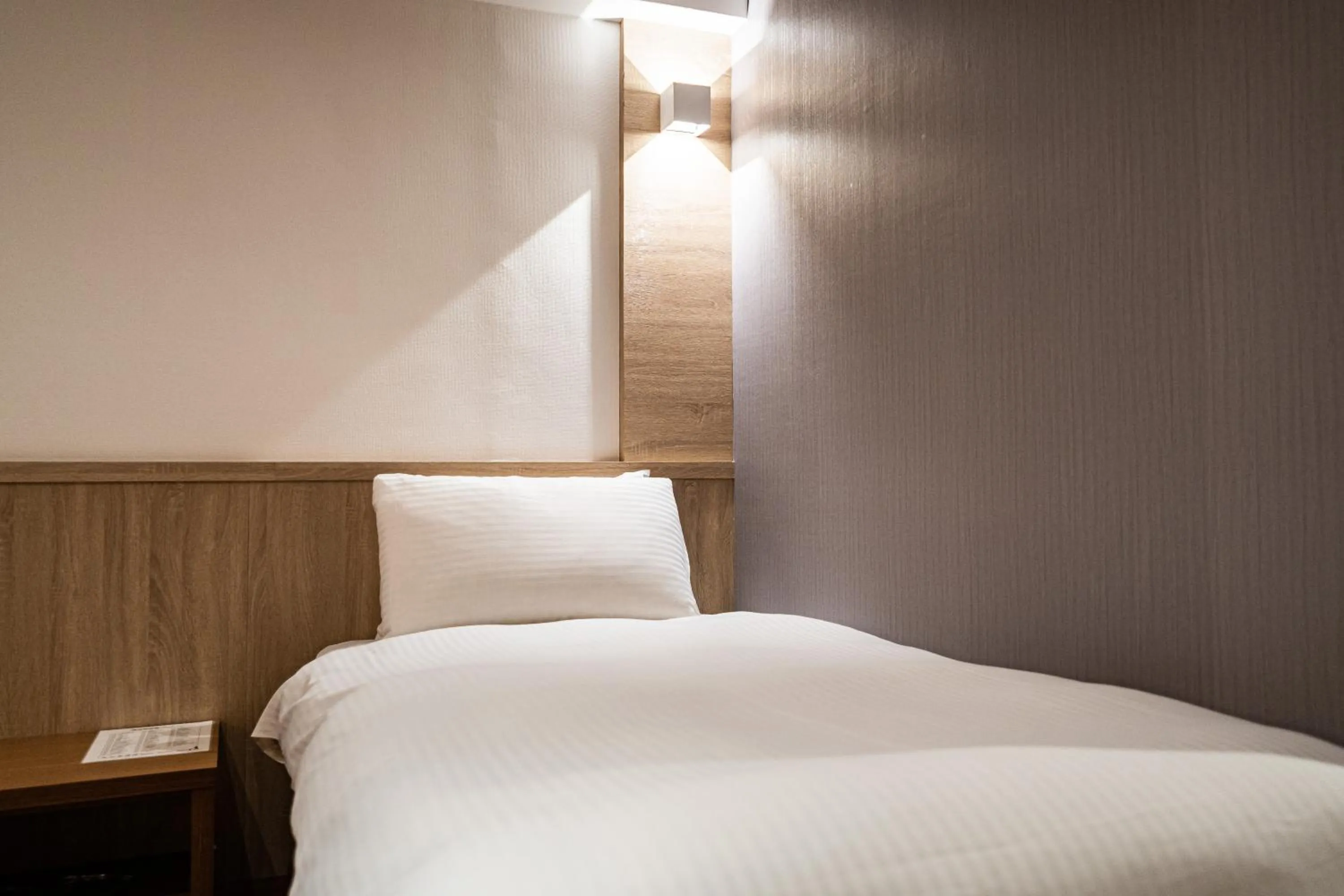 Bed in Global Traveler Hotel