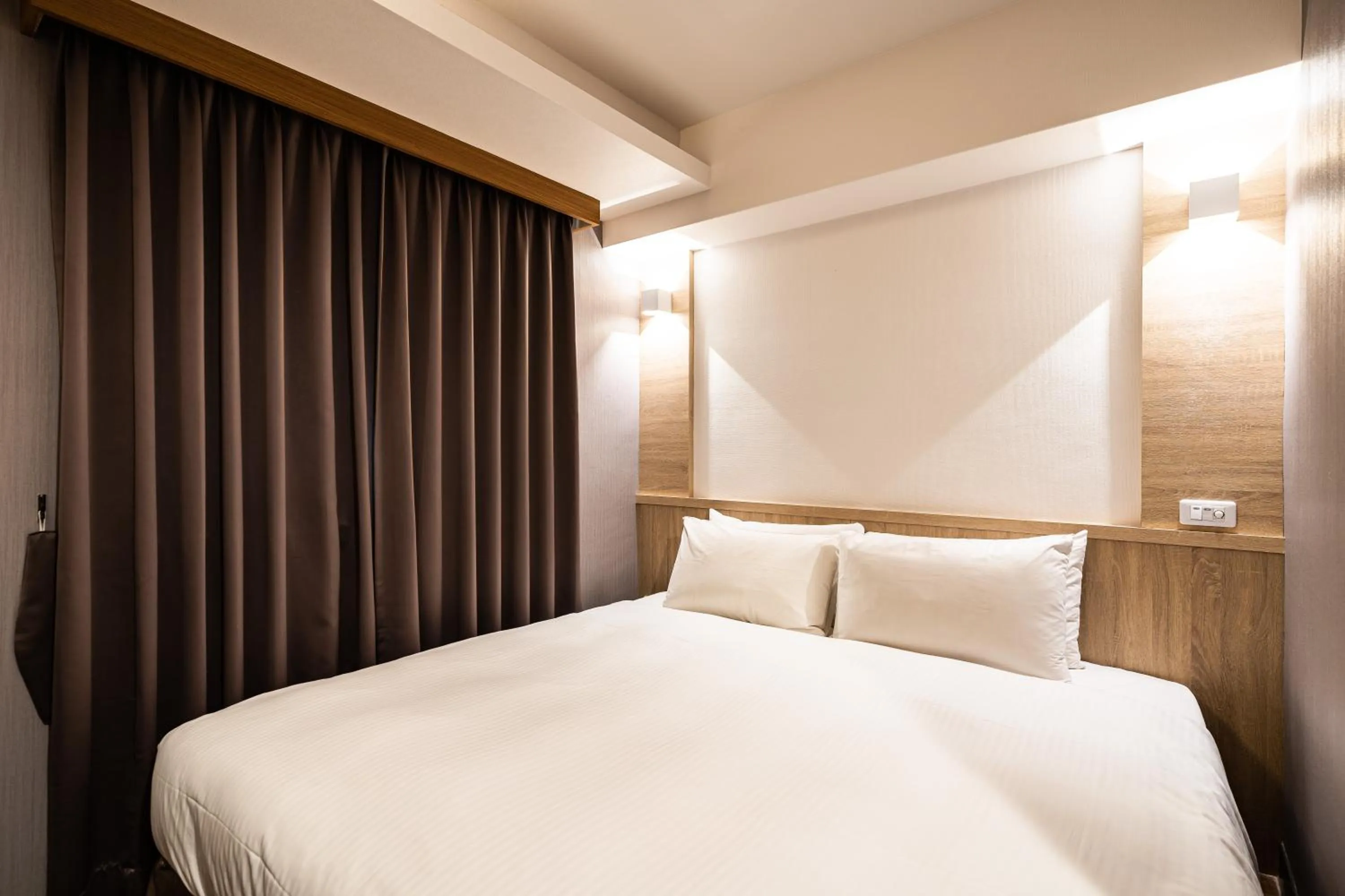 Bed in Global Traveler Hotel