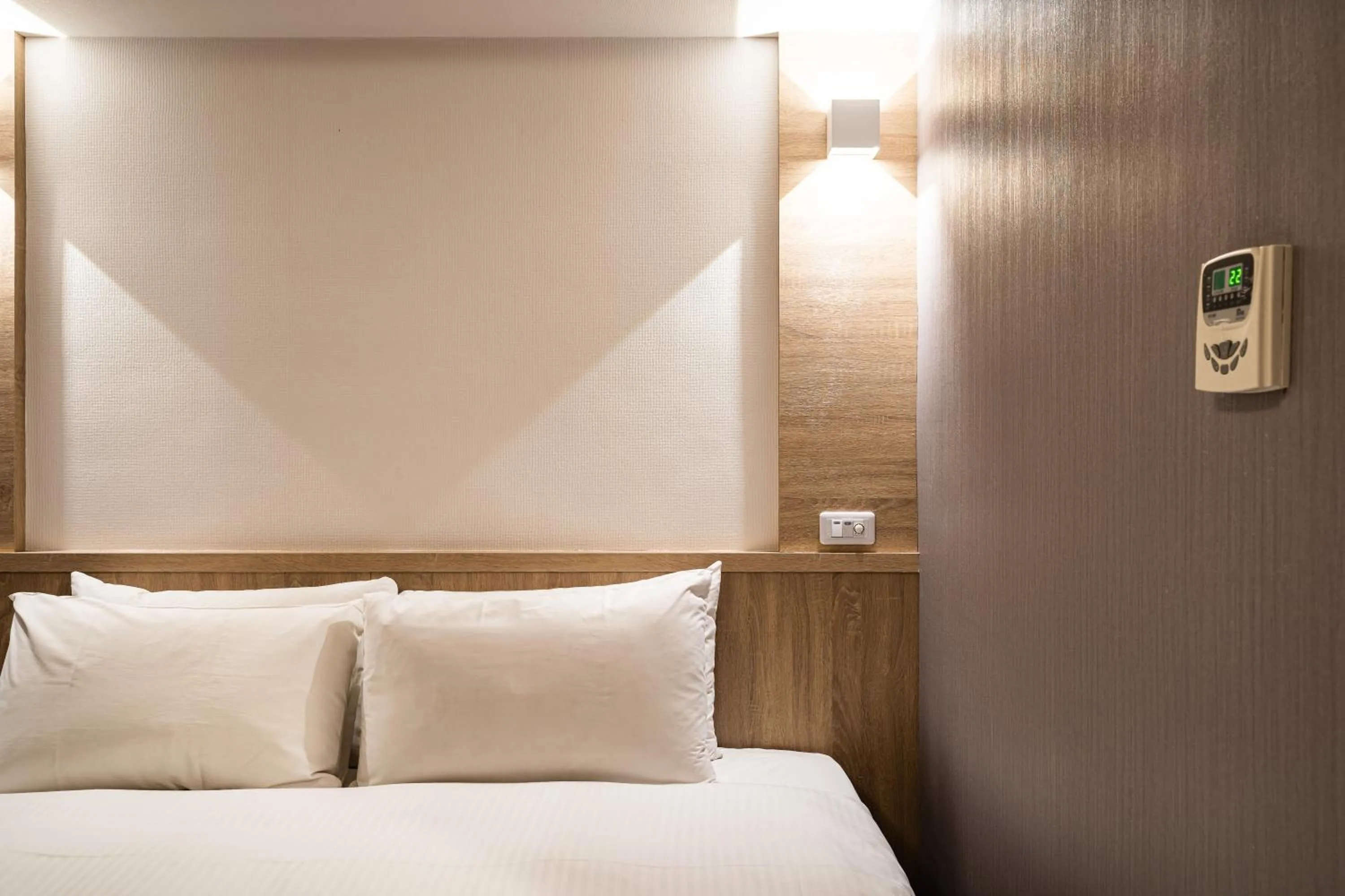 Bed in Global Traveler Hotel