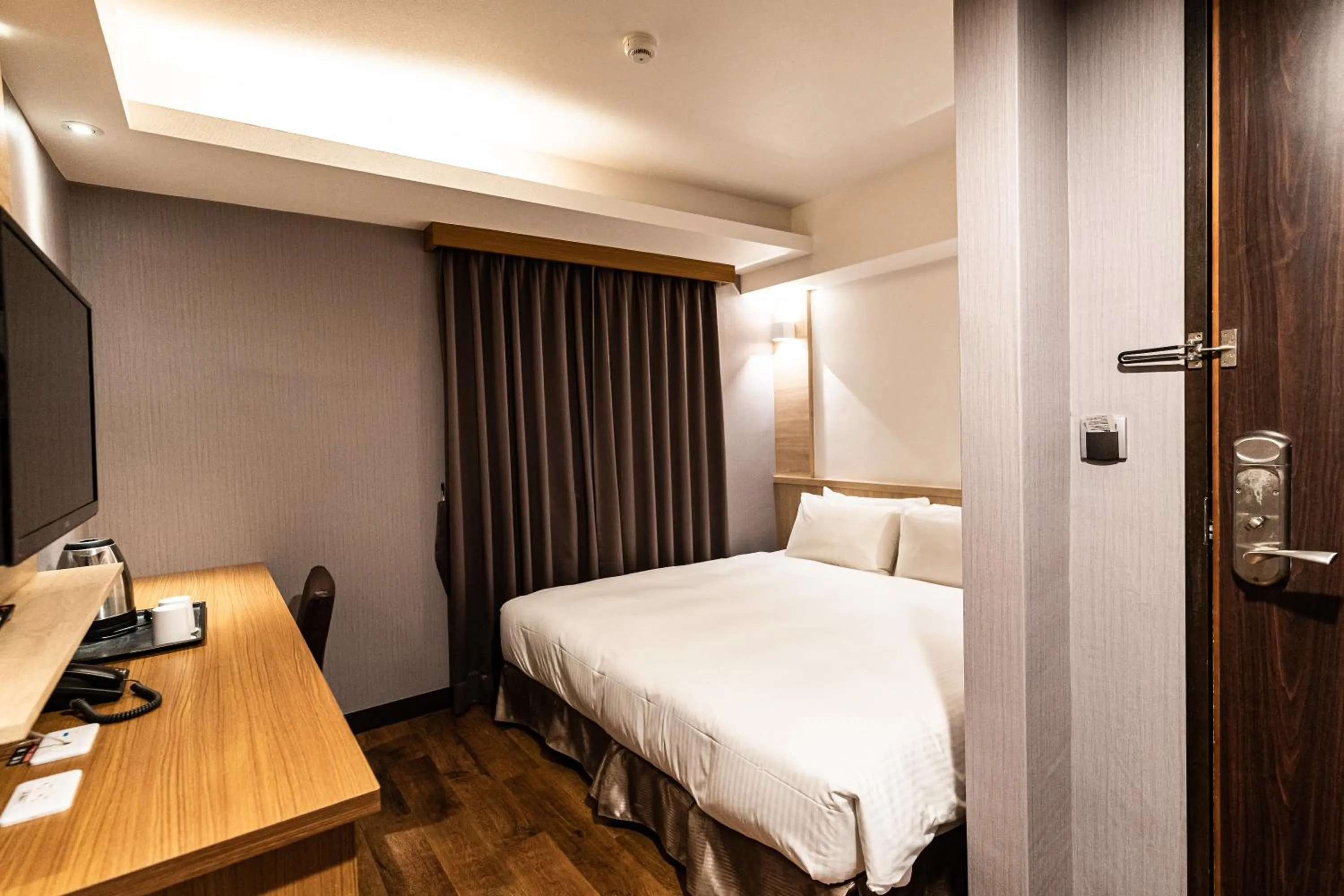 Bed in Global Traveler Hotel