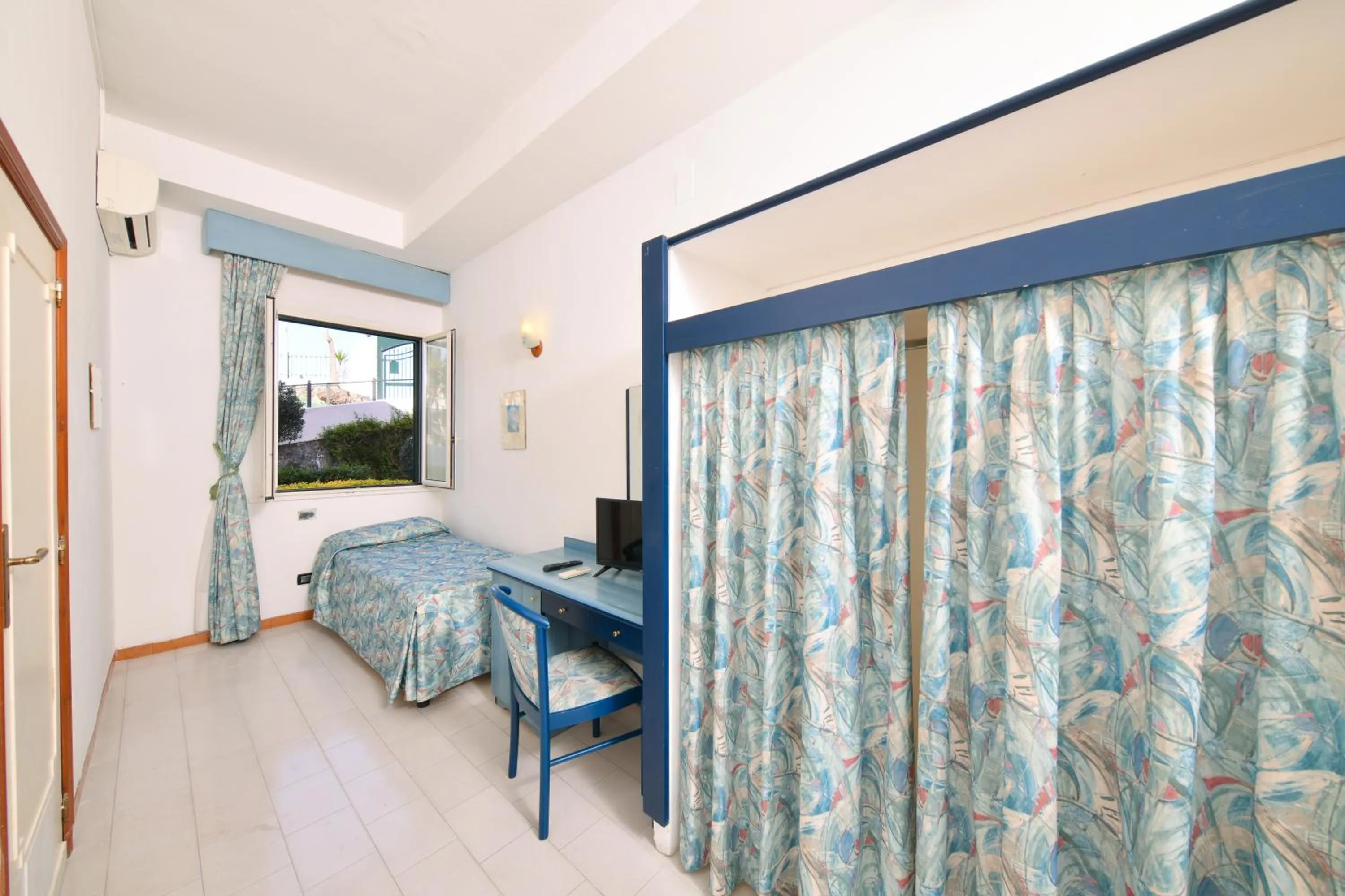 Bedroom, Seating Area in Fortuna Beach - Seaside Hotel