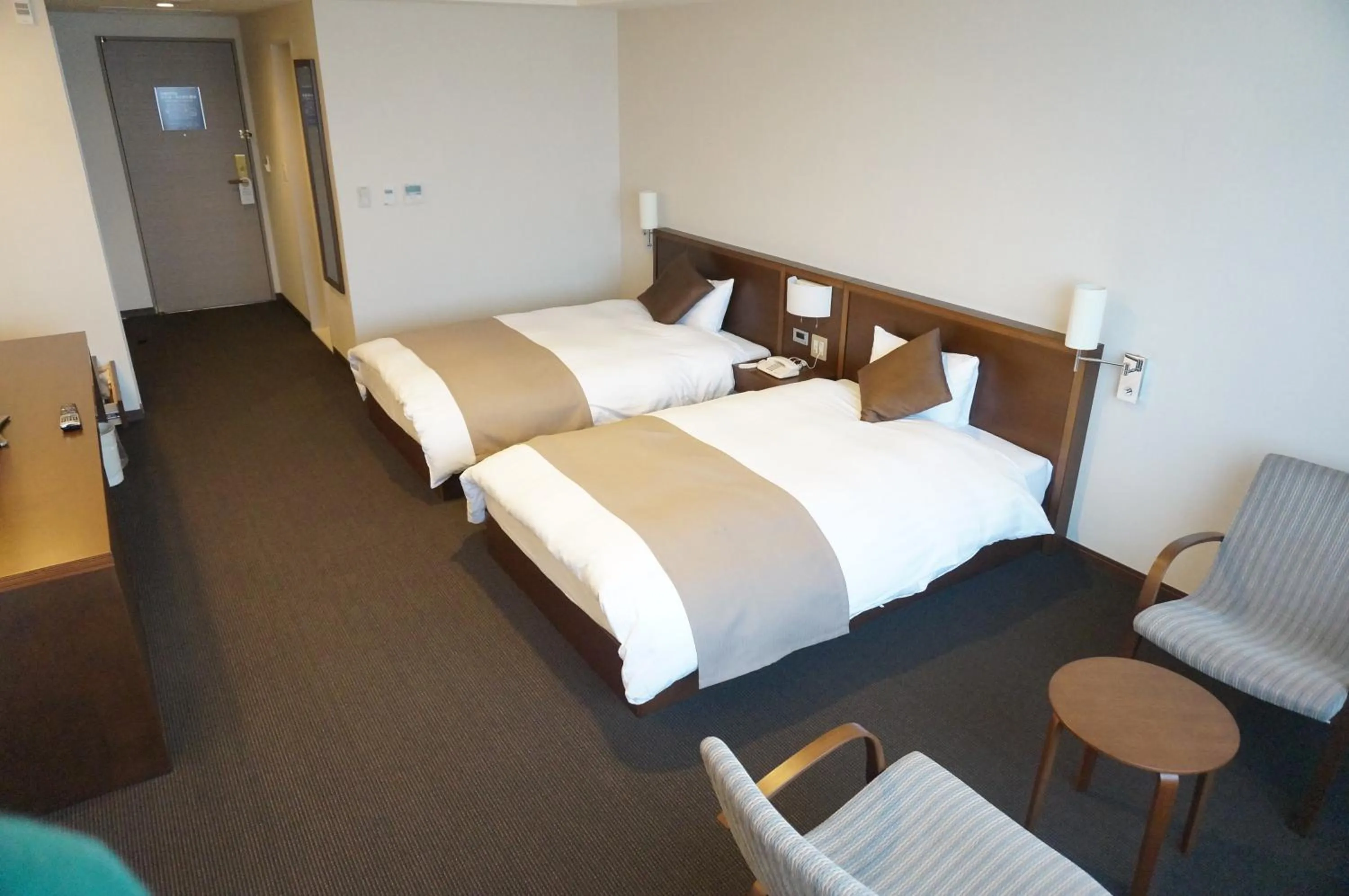 Bed in Kiyosato Onsen Hotel Ryokuseisou