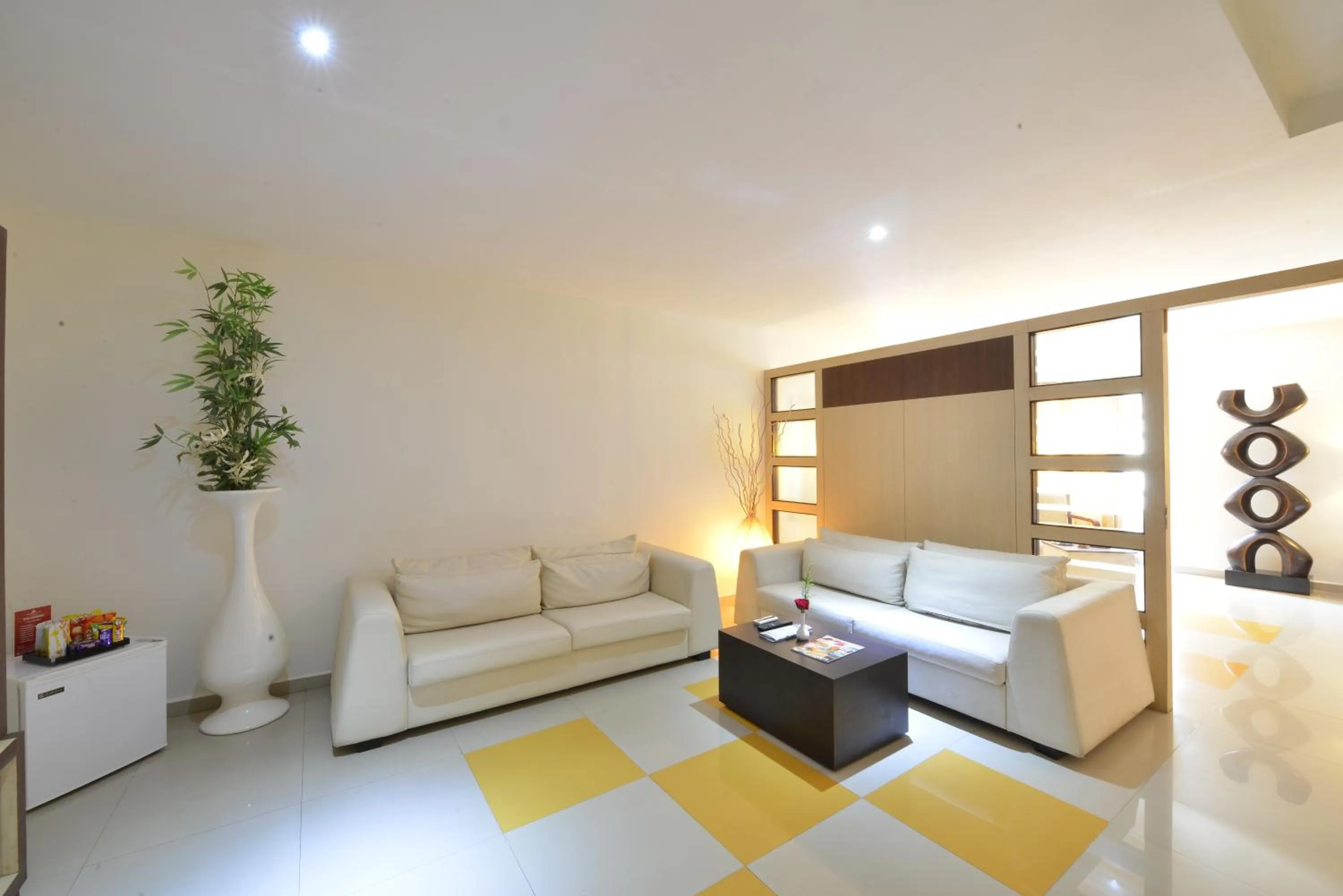 Living room, Bed in SRM Hotel