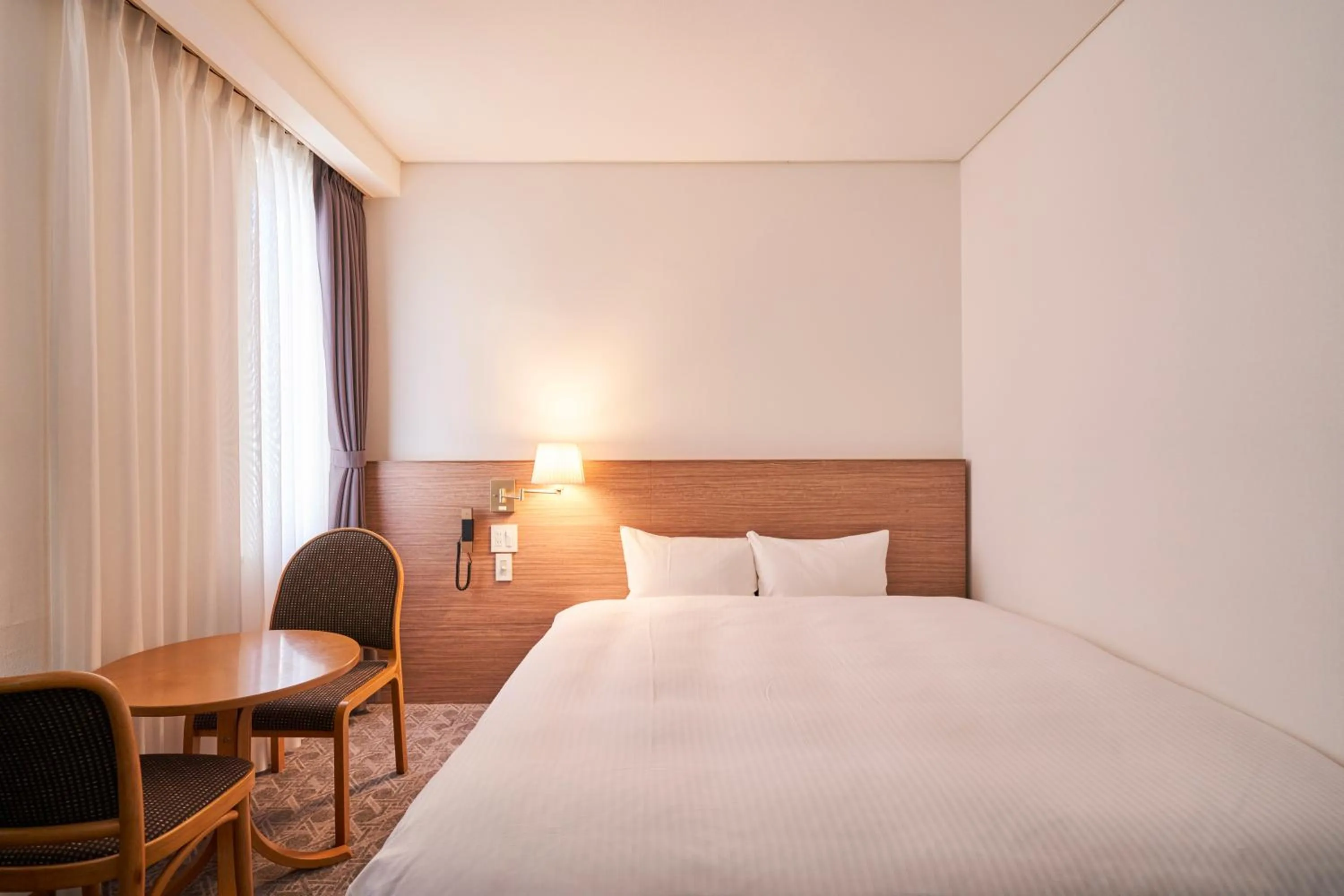 Bed in Mito Sannomaru Hotel